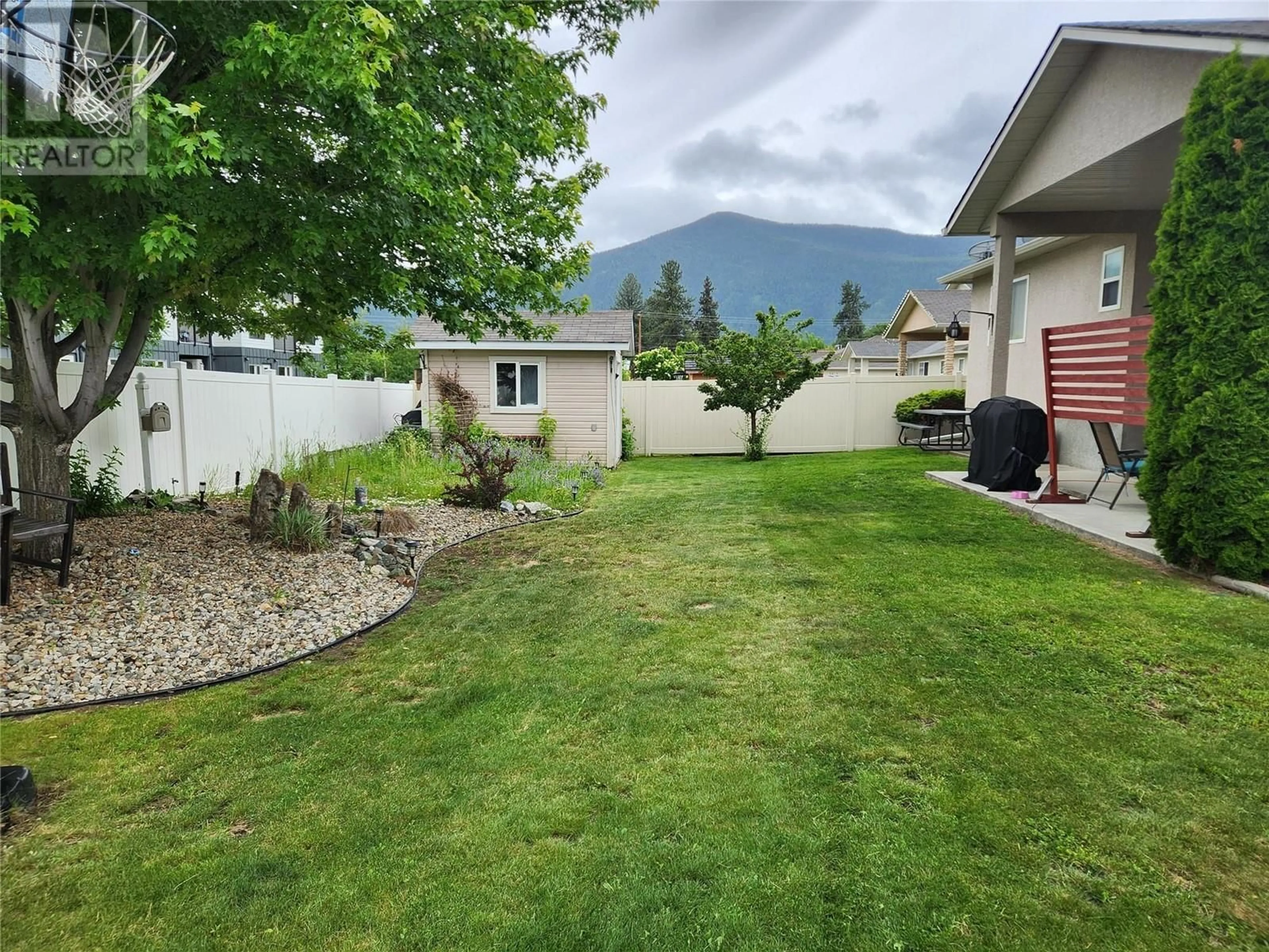 Frontside or backside of a home, the fenced backyard for 2160 BRYCEN Place, Grand Forks British Columbia V0H1H0