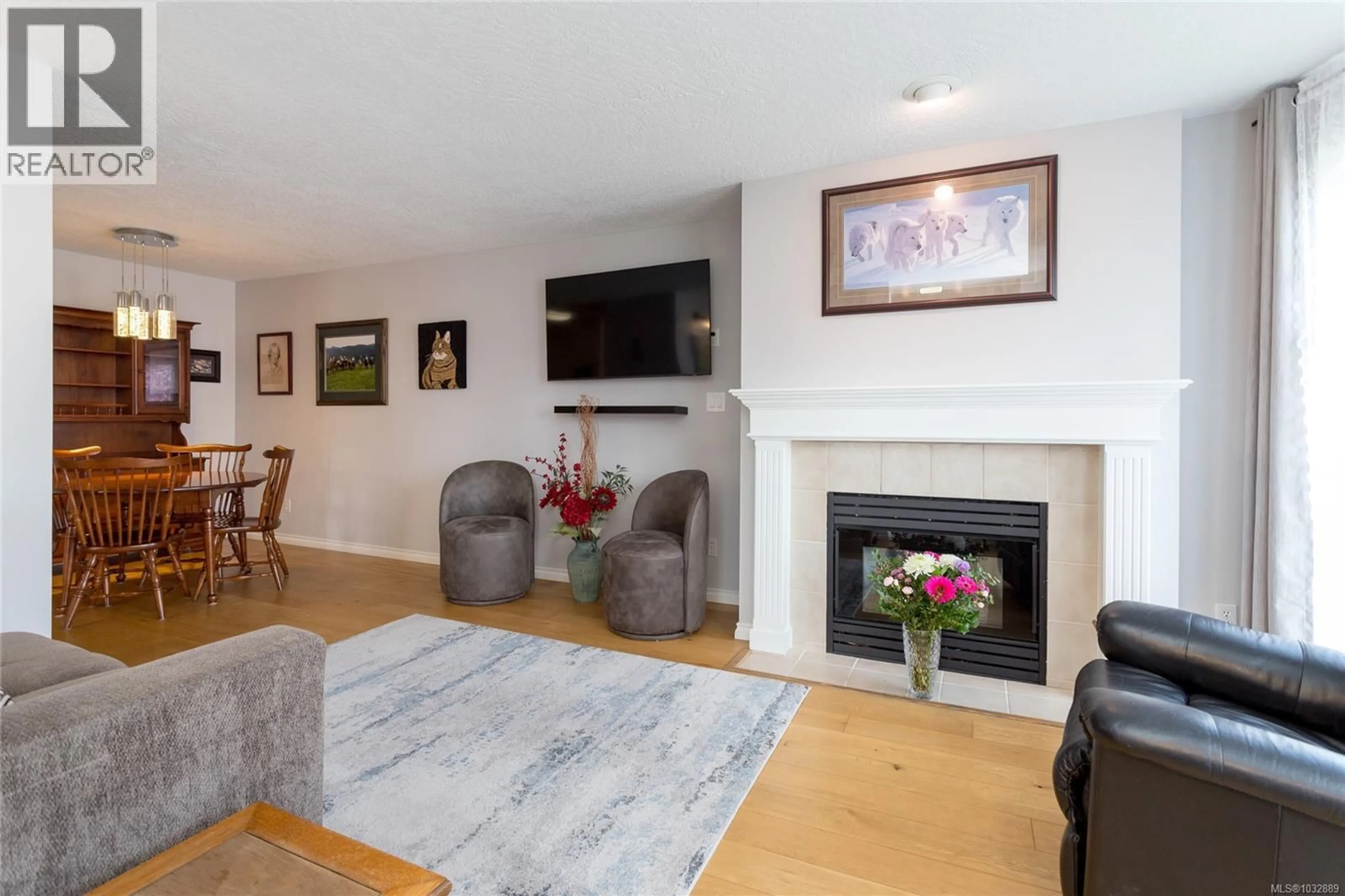 Living room with furniture, wood/laminate floor for 303 - 899 DARWIN AVENUE, Saanich British Columbia V8X2X7