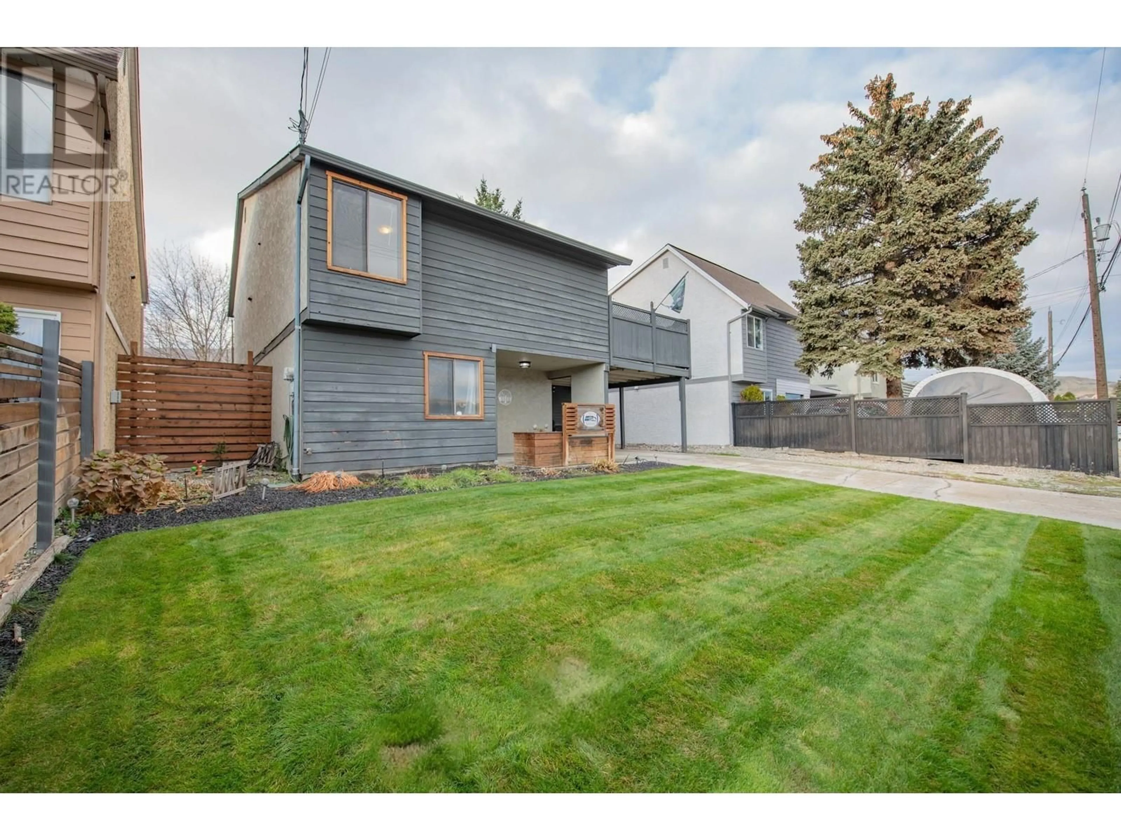 Frontside or backside of a home, the fenced backyard for 5513 27 Avenue, Vernon British Columbia V1T7A3