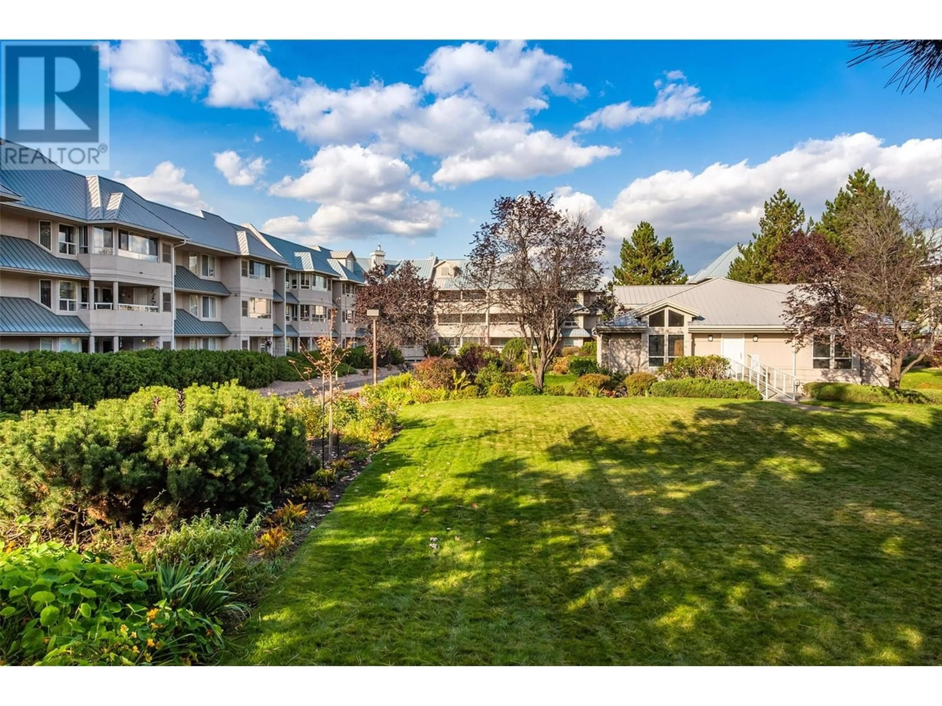 A pic from exterior of the house or condo, the fenced backyard for 1961 Durnin Road Unit# 305, Kelowna British Columbia V1X7Z6