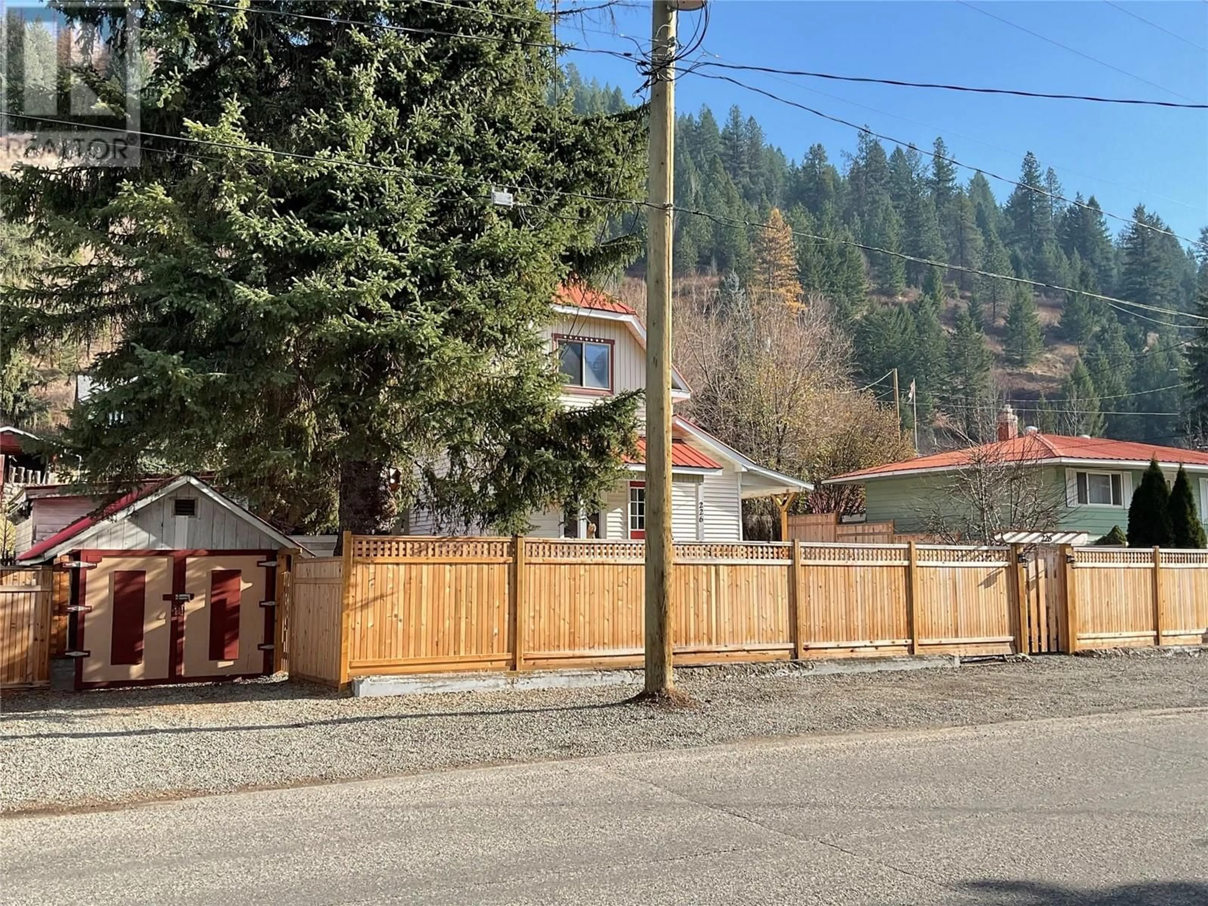 Frontside or backside of a home, the fenced backyard for 226 KIMBERLEY  N Avenue, Greenwood British Columbia V0H1J0