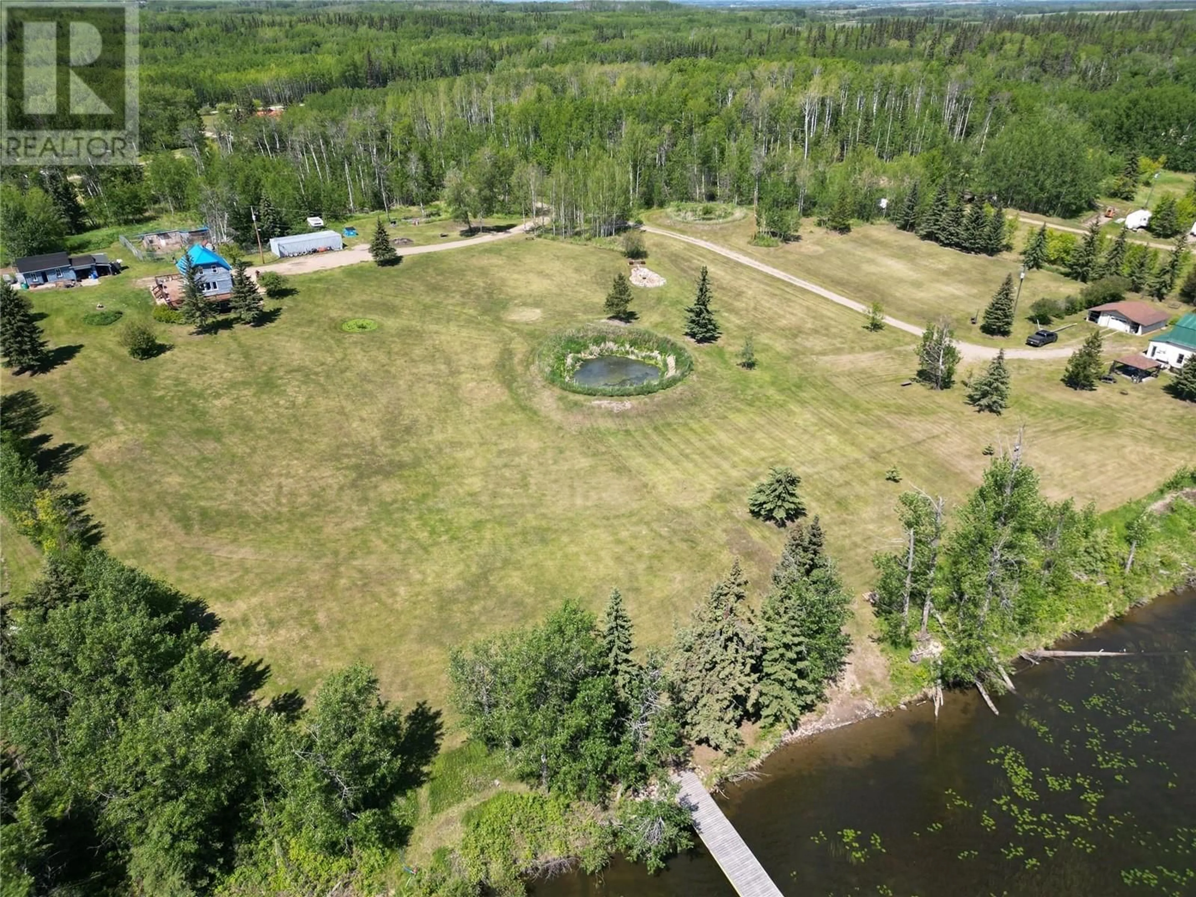 A pic from exterior of the house or condo, the fenced backyard for 16020 Tupper Village Way, Dawson Creek British Columbia V0C0B7