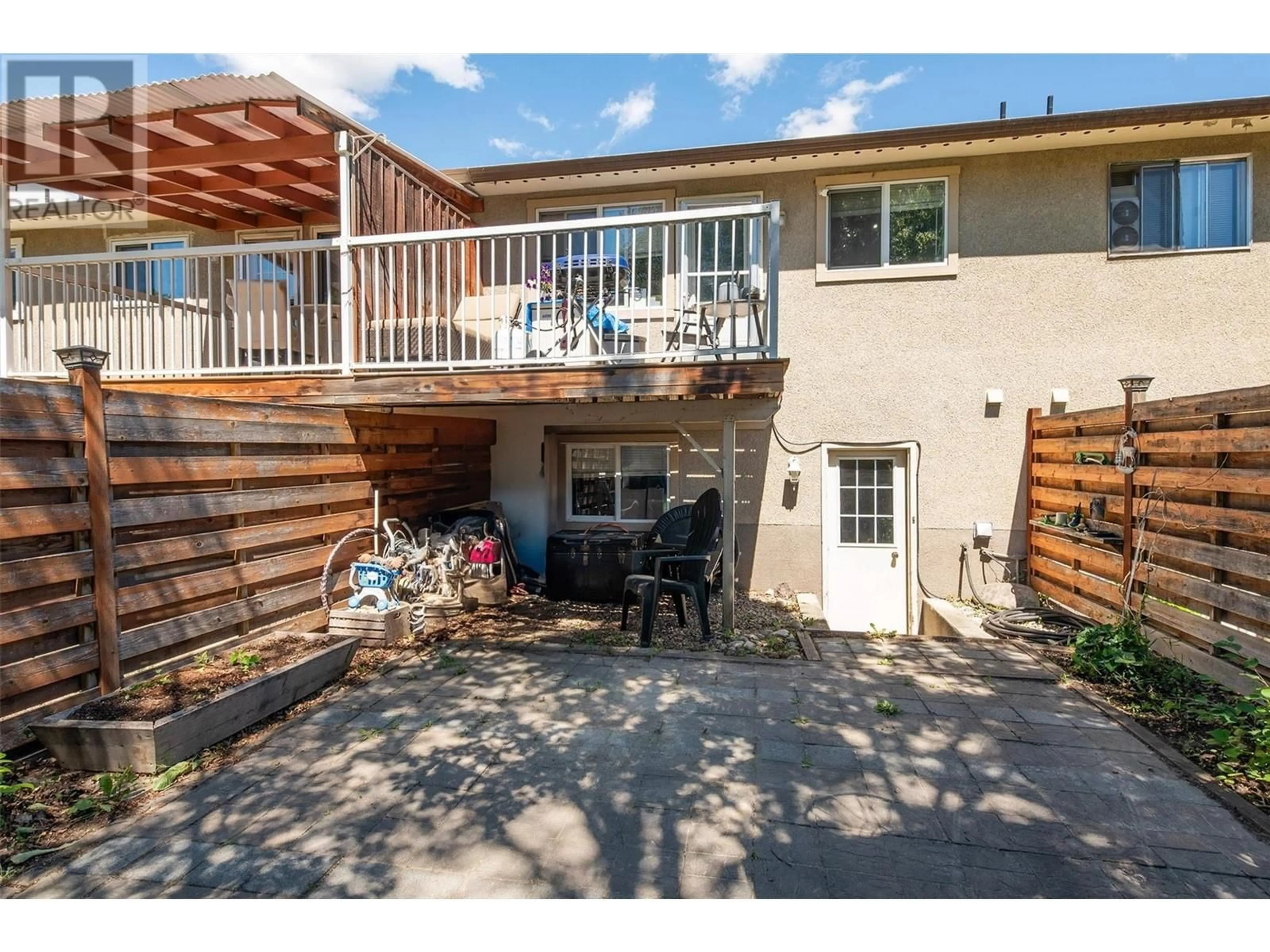 A pic from exterior of the house or condo, the fenced backyard for 265 Fir Court, Kelowna British Columbia V1X2B8