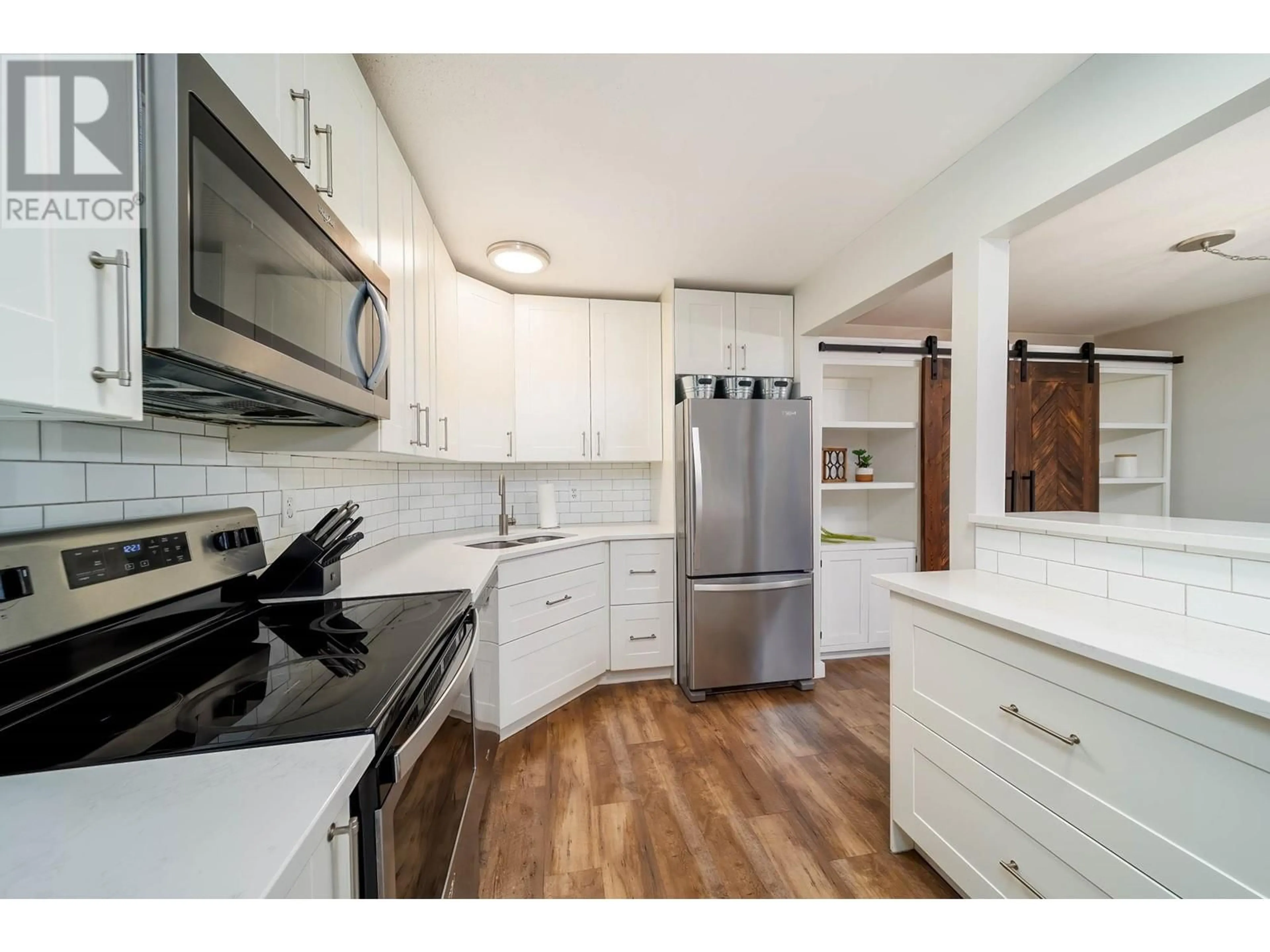 Standard kitchen, wood floors for 575 Doyle Avenue Unit# 102, Kelowna British Columbia V1Y9N2