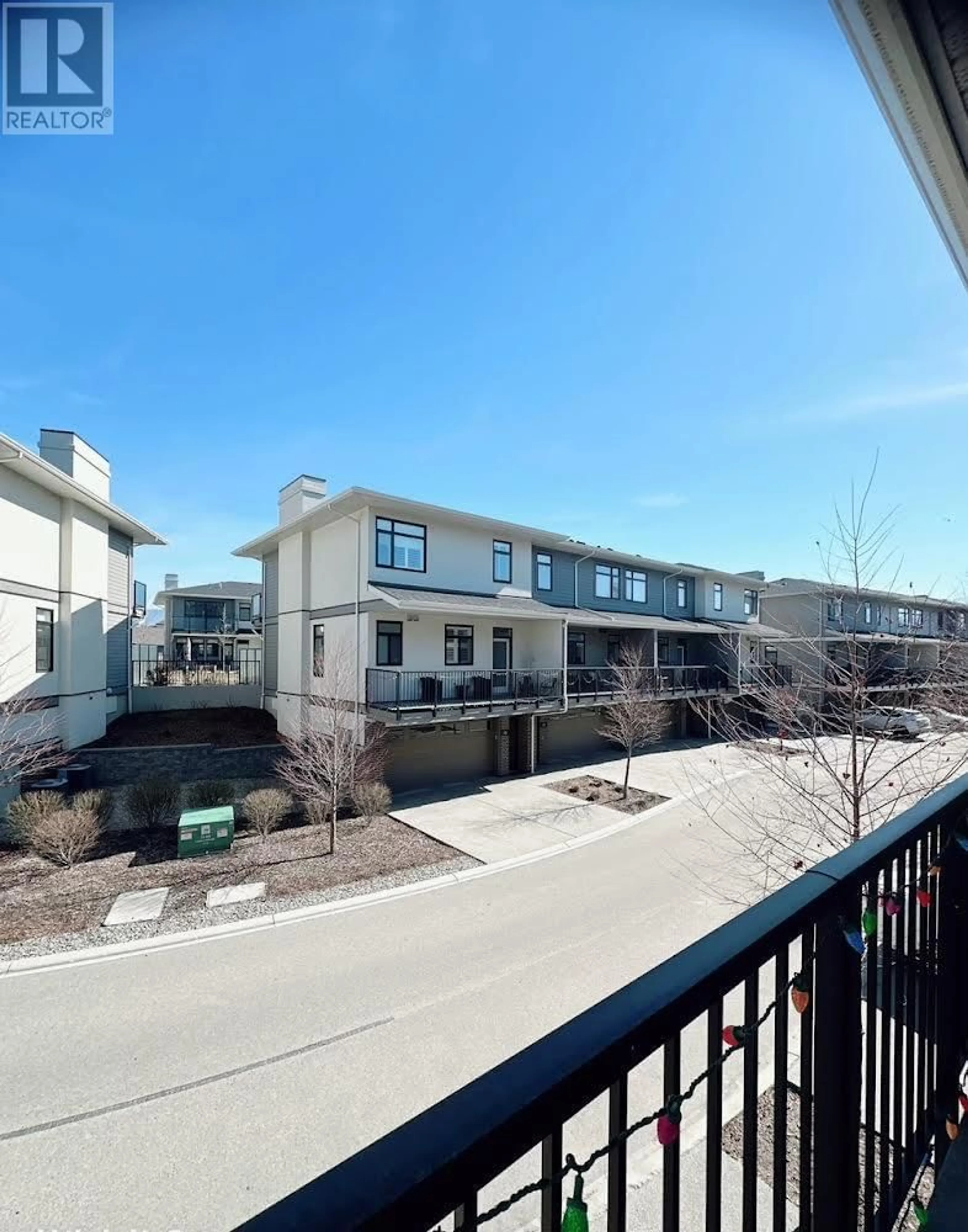 A pic from exterior of the house or condo, the fenced backyard for 1102 Cameron Avenue Unit# 26, Kelowna British Columbia V1Y0B2