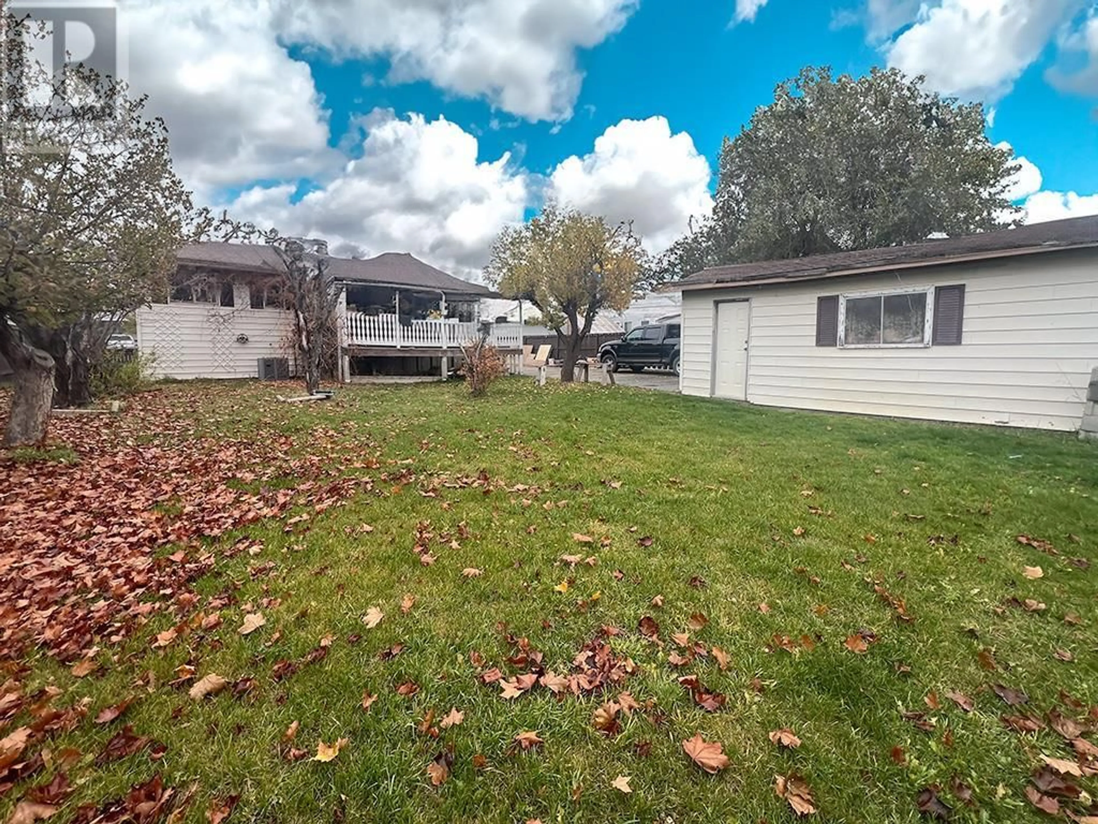 Frontside or backside of a home, the fenced backyard for 2138 Clarke Avenue, Merritt British Columbia V1K1B8