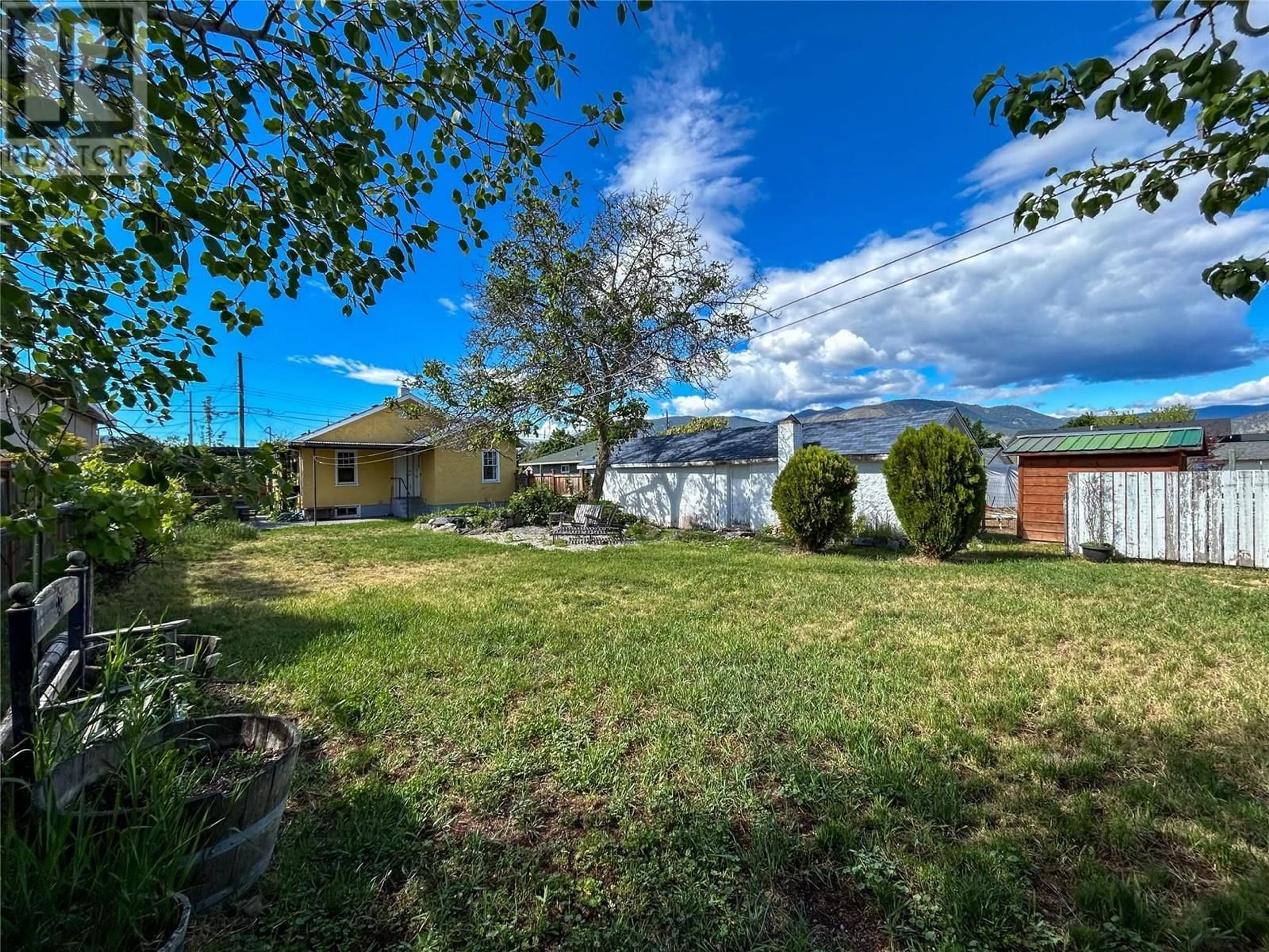 Frontside or backside of a home, the fenced backyard for 325 Nelson Avenue, Penticton British Columbia V2A2L1