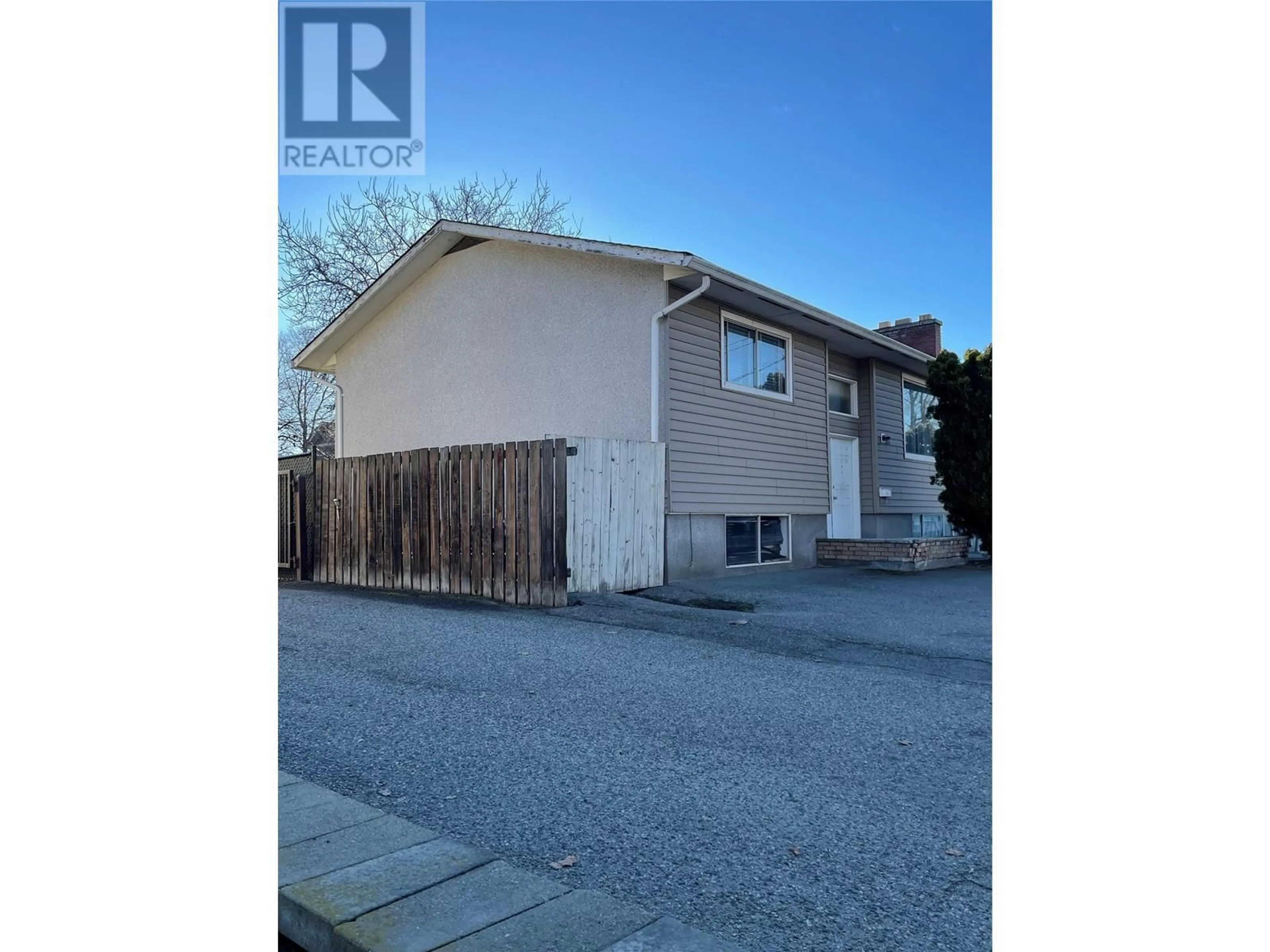 Frontside or backside of a home, the street view for 3049 Gordon Drive, Kelowna British Columbia V1W3R1