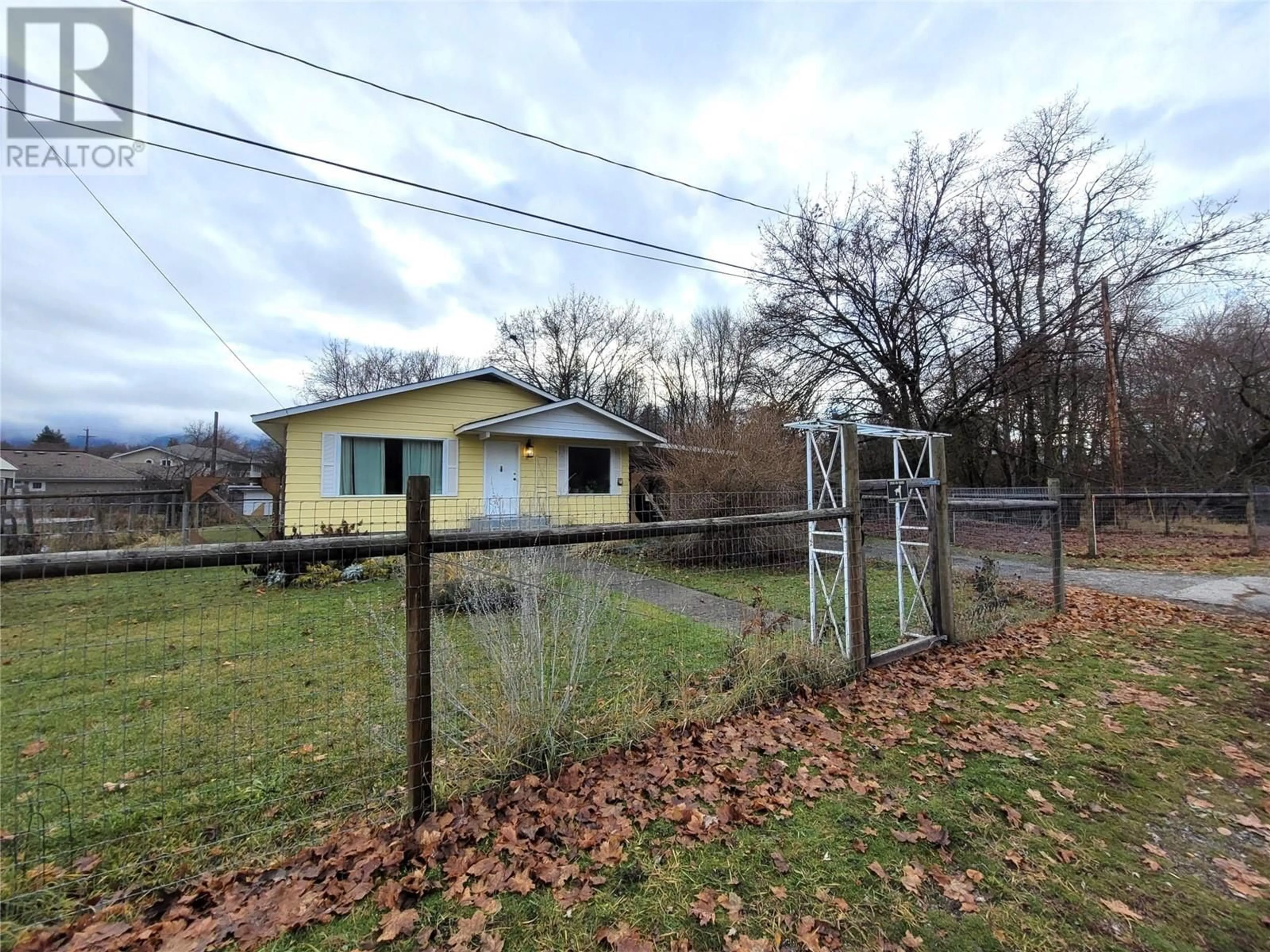 Frontside or backside of a home, the fenced backyard for 750 75TH Avenue, Grand Forks British Columbia V0H1H0