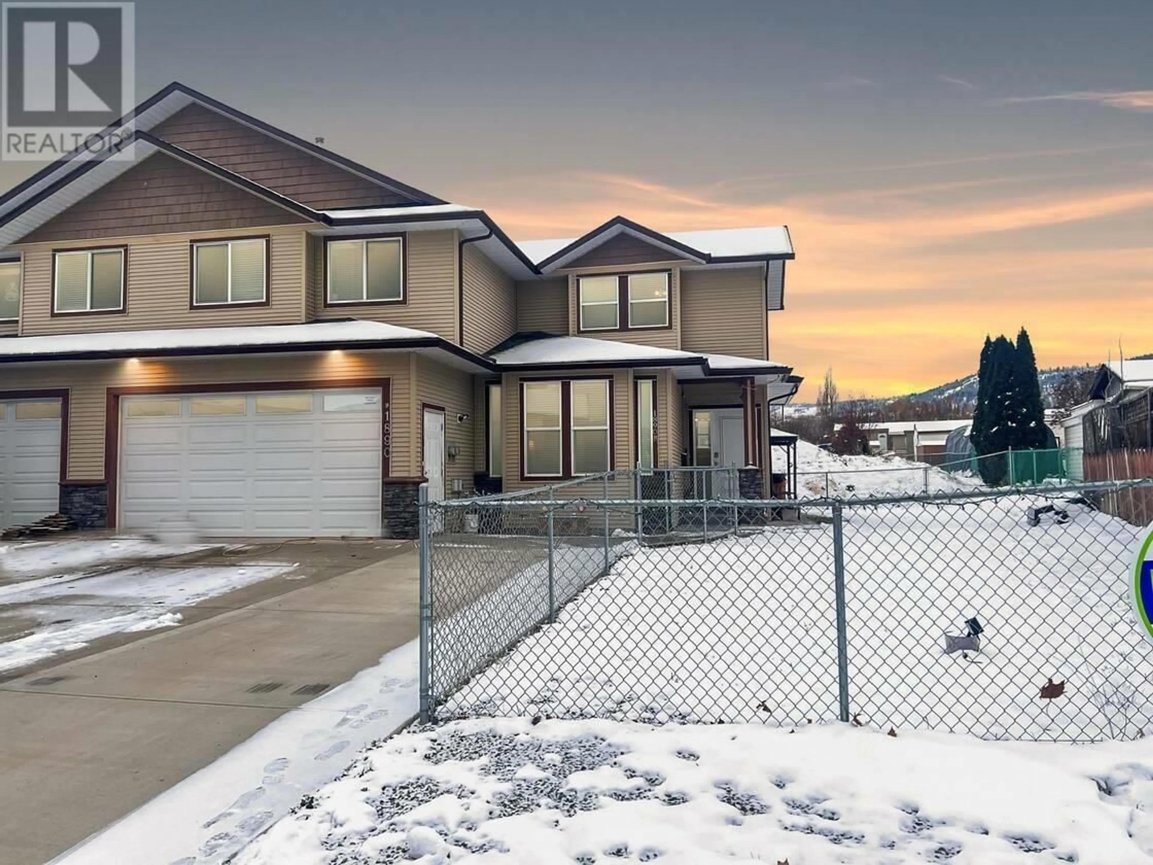 Frontside or backside of a home, the fenced backyard for 1890B Sage Street, Merritt British Columbia V1K1G3