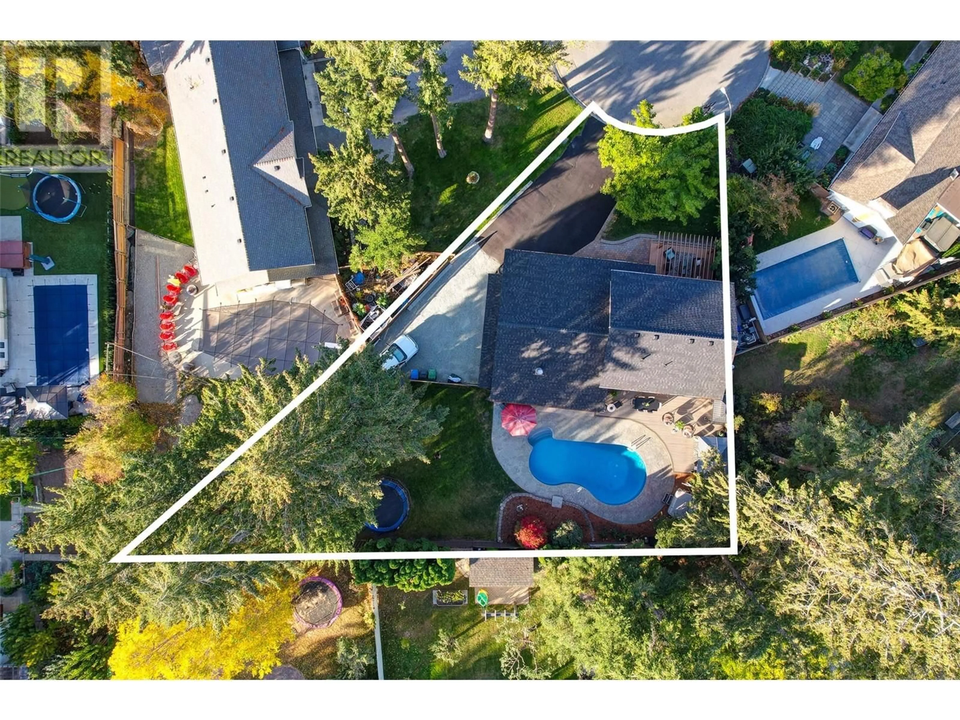 Frontside or backside of a home, the fenced backyard for 827 Coronado Court, Kelowna British Columbia V1W2C4