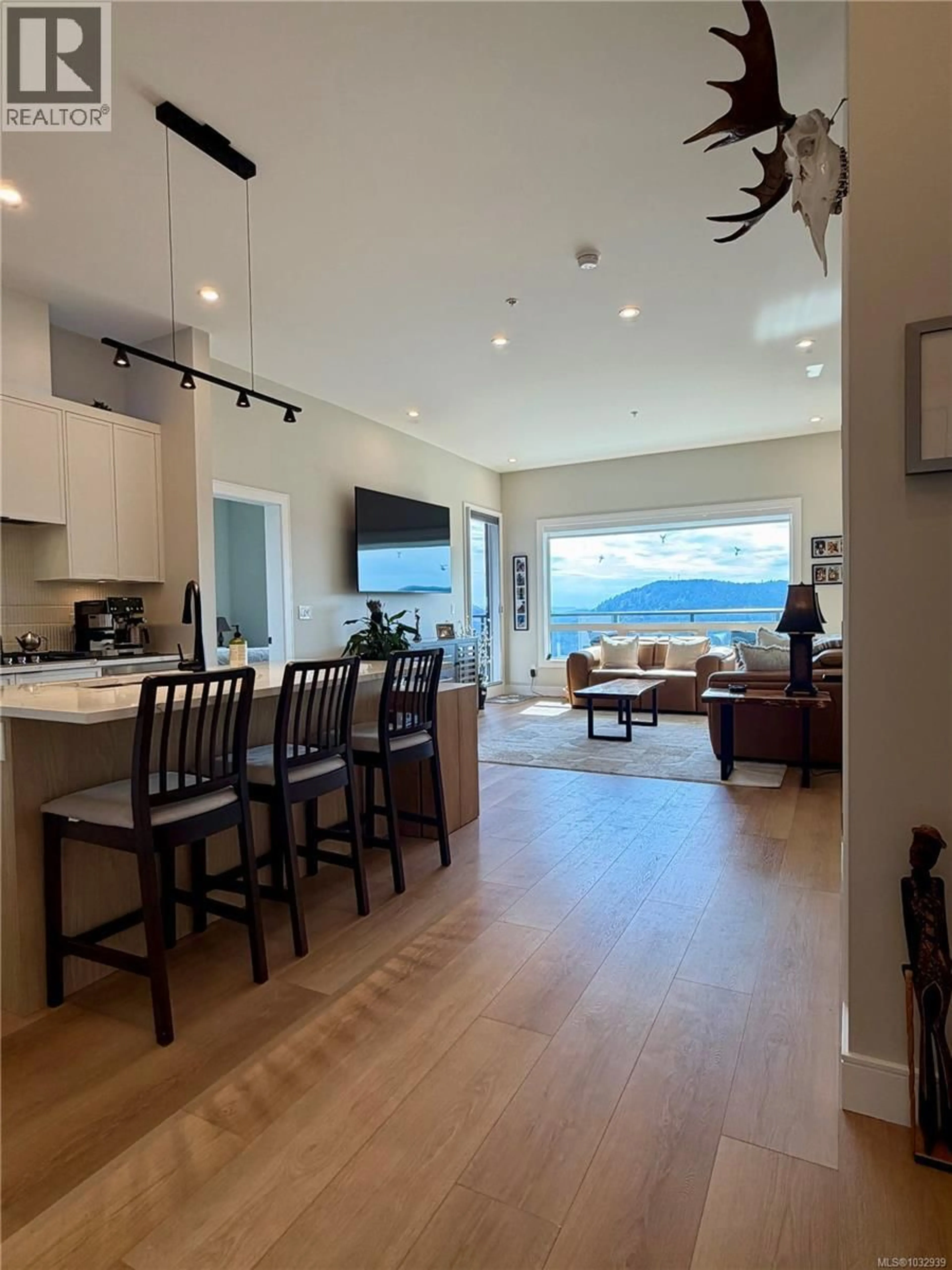 Open concept kitchen, wood/laminate floor for 614 - 1810 SELENITE PLACE, Langford British Columbia V9B7E2