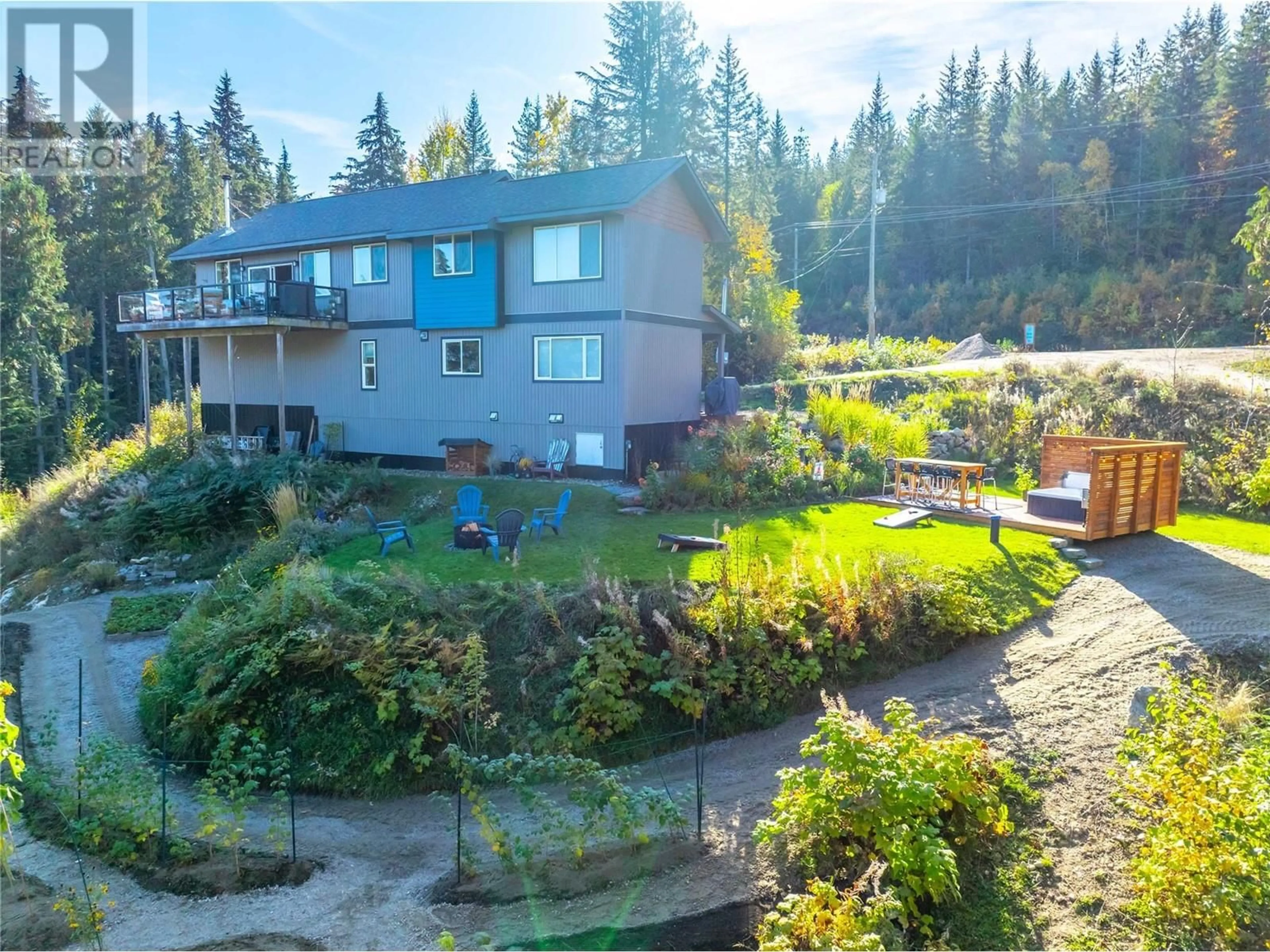 Frontside or backside of a home, the fenced backyard for 8200 23 Highway S, Revelstoke British Columbia V0E2S0