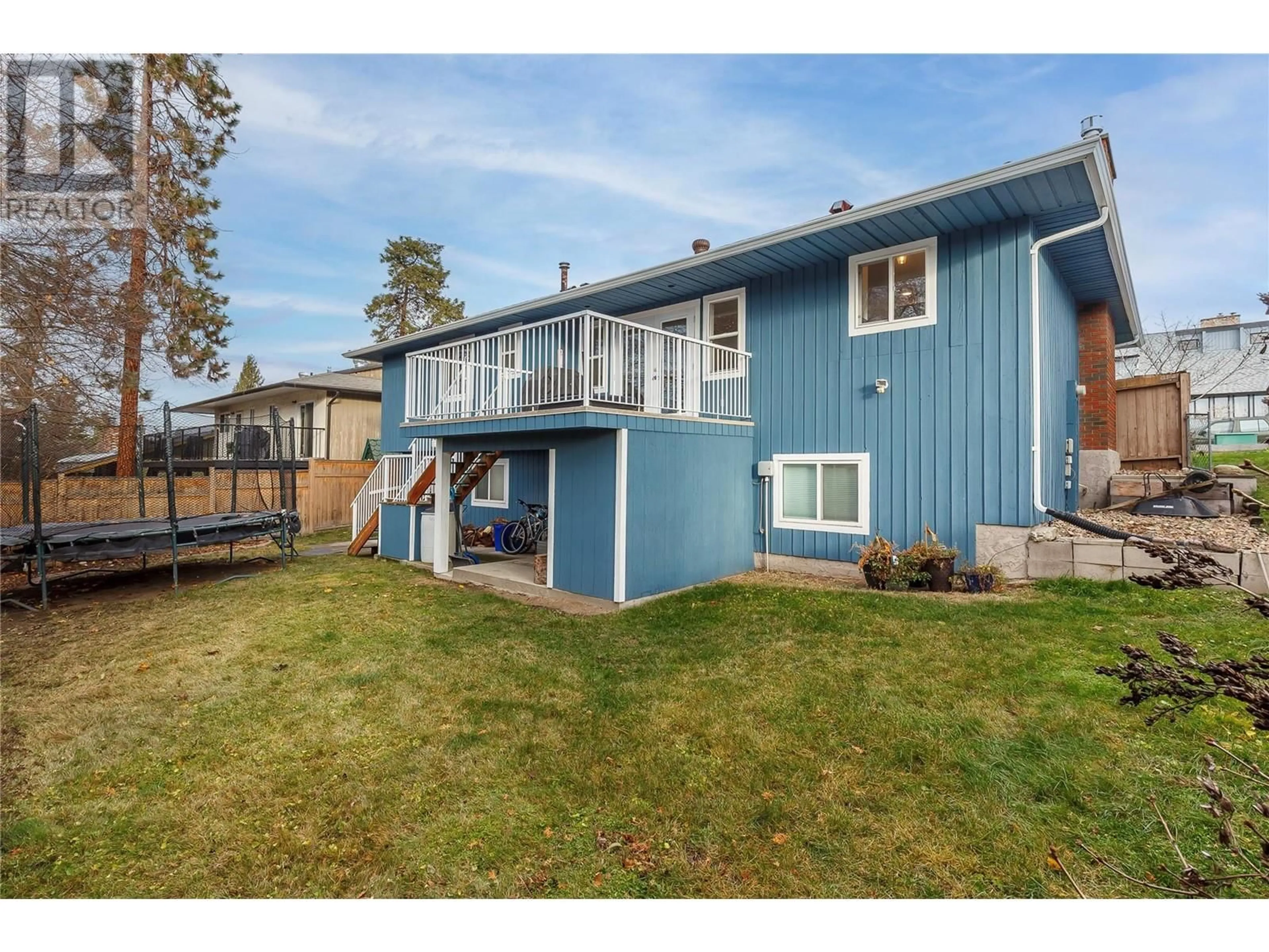 Frontside or backside of a home, the fenced backyard for 3908 15 Street, Vernon British Columbia V1T7X1