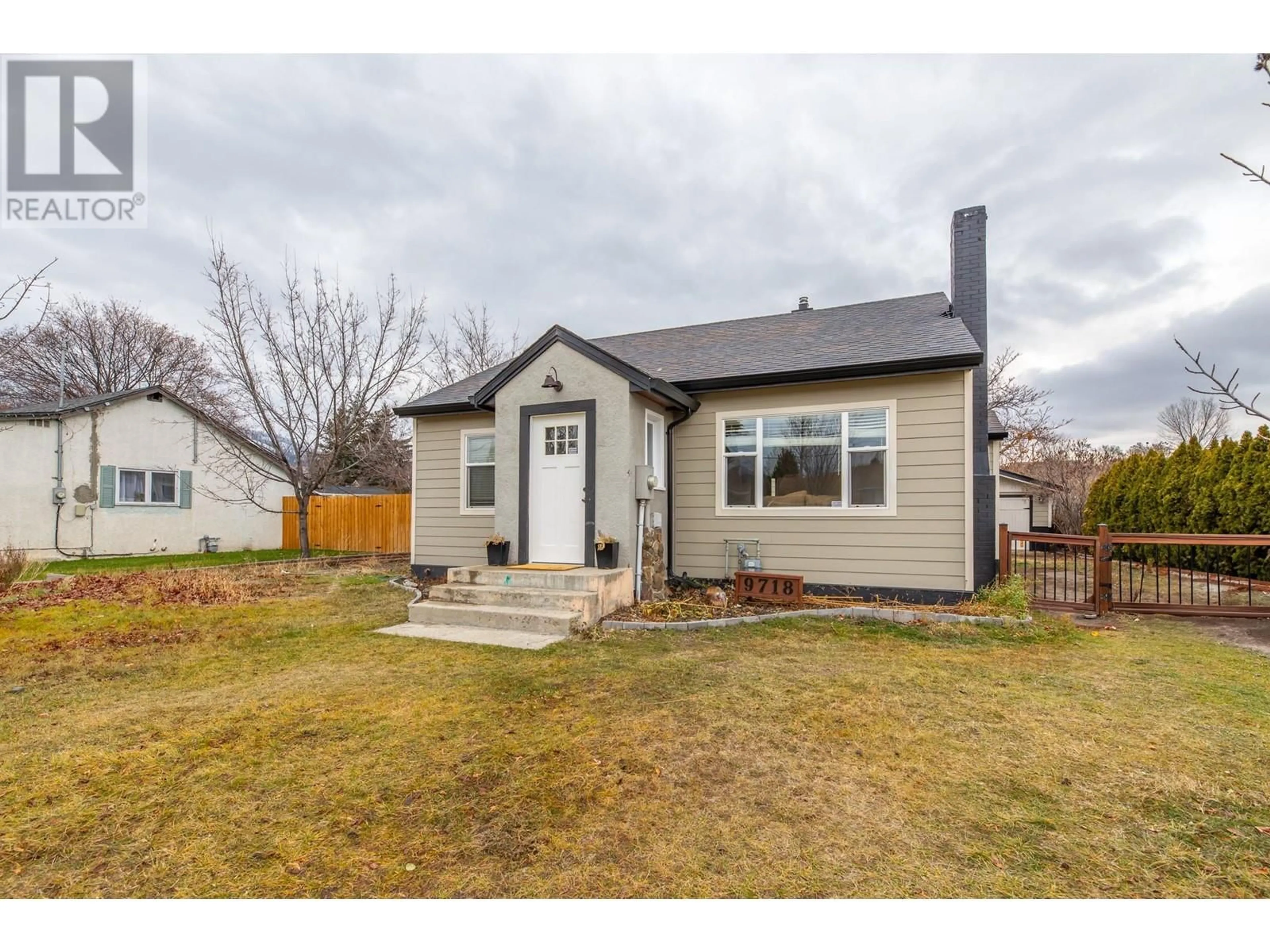 Frontside or backside of a home, the fenced backyard for 9718 Julia Street, Summerland British Columbia V0H1Z6