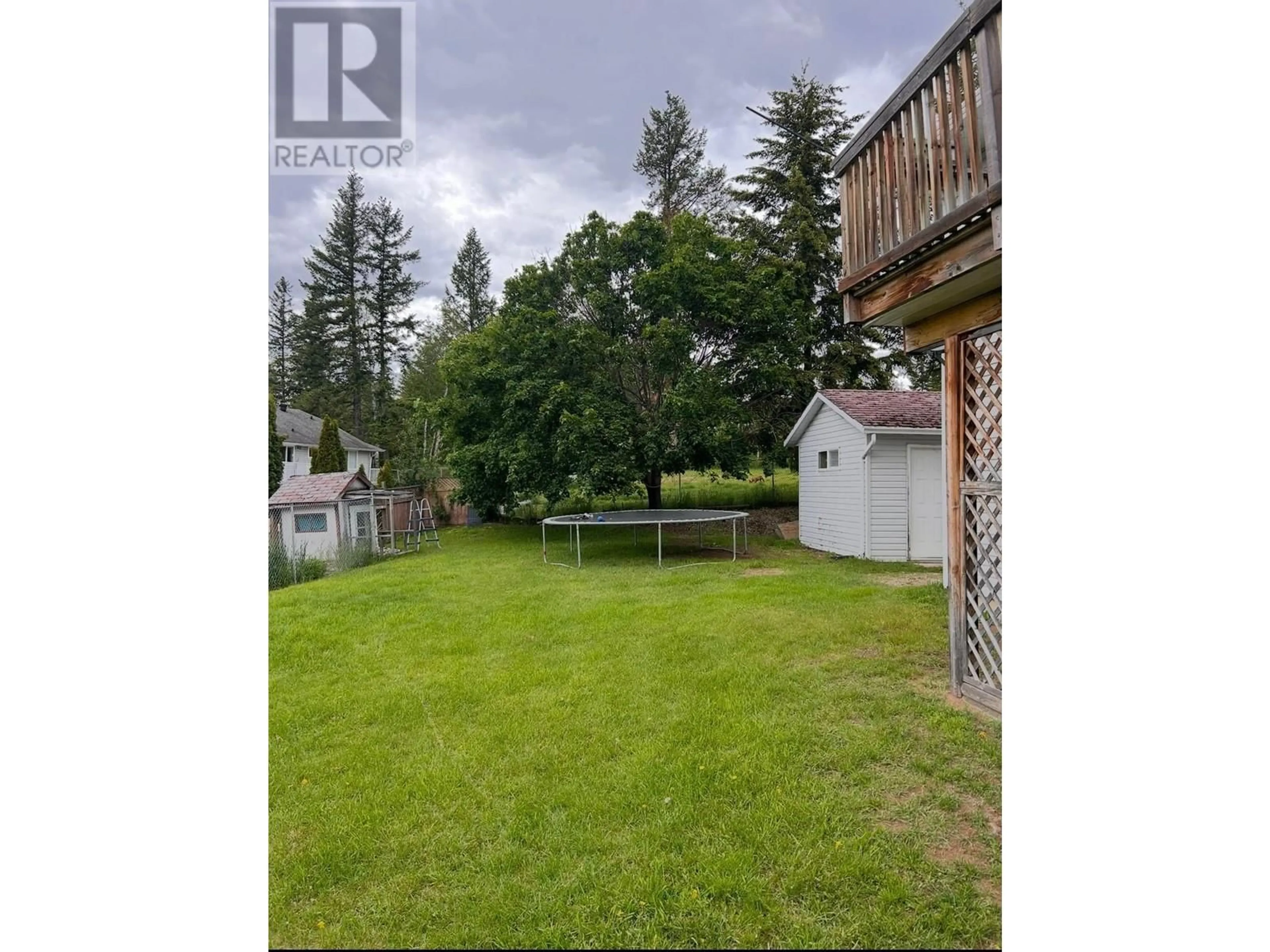 Frontside or backside of a home, the fenced backyard for 581 Fawn Road, Clearwater British Columbia V0E1N1