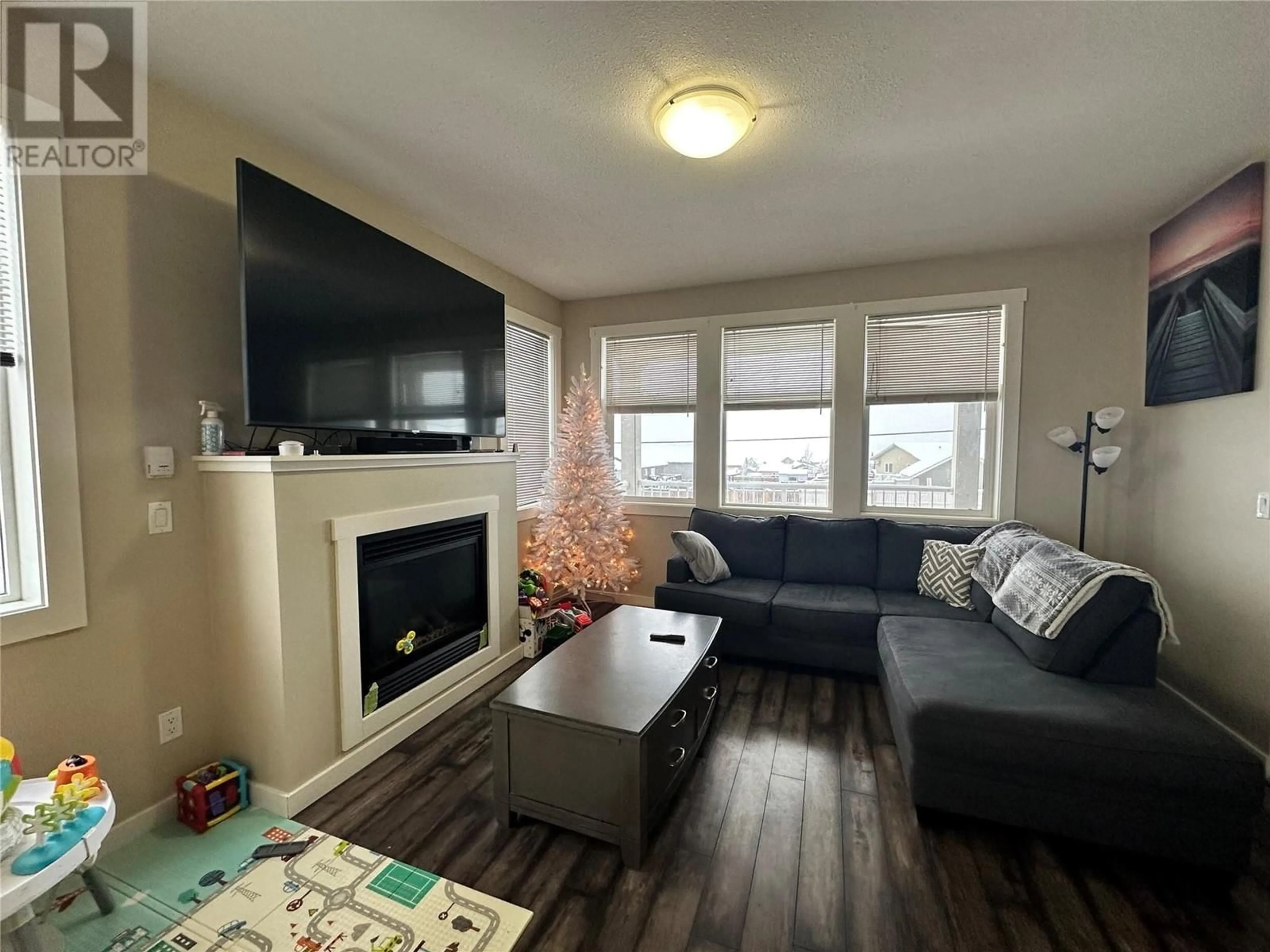 Living room with furniture, wood/laminate floor for 8708 17 STREET, Dawson Creek British Columbia V1G0H1
