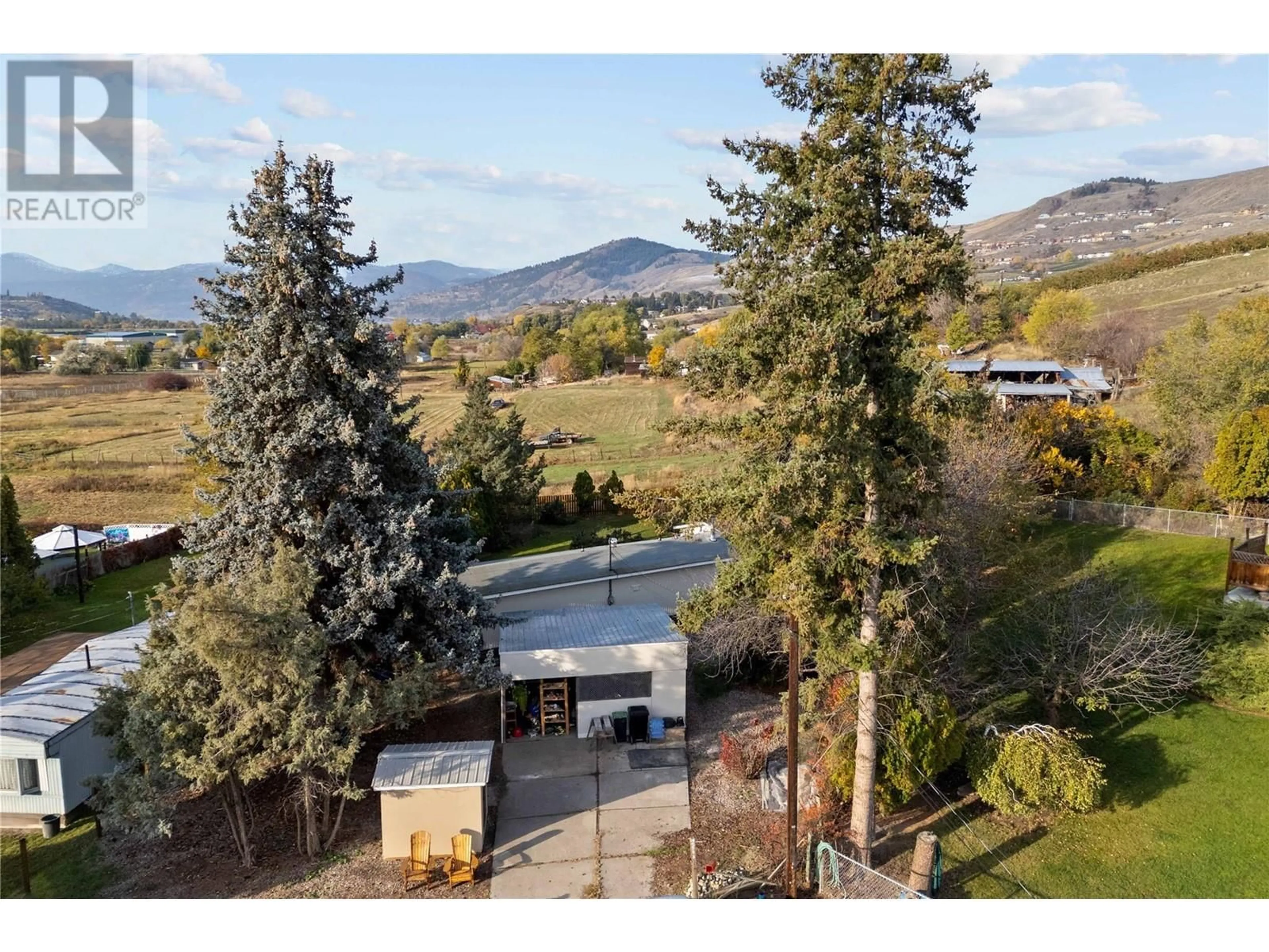 A pic from exterior of the house or condo, the fenced backyard for 2544 Willow Park Road, Vernon British Columbia V1H1M4