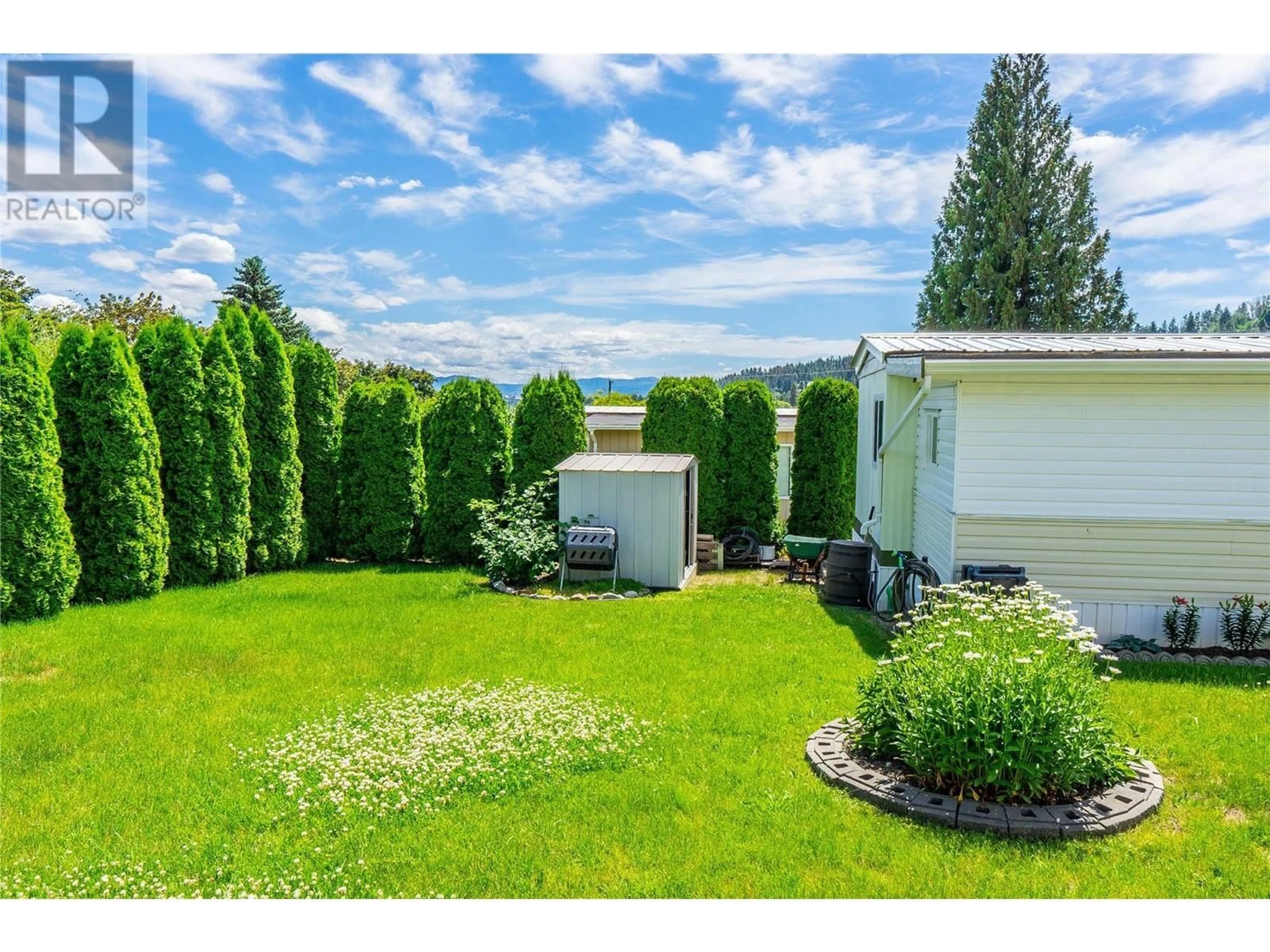 Frontside or backside of a home, the fenced backyard for 12022 Pretty Road Unit# 17, Lake Country British Columbia V4V1H1