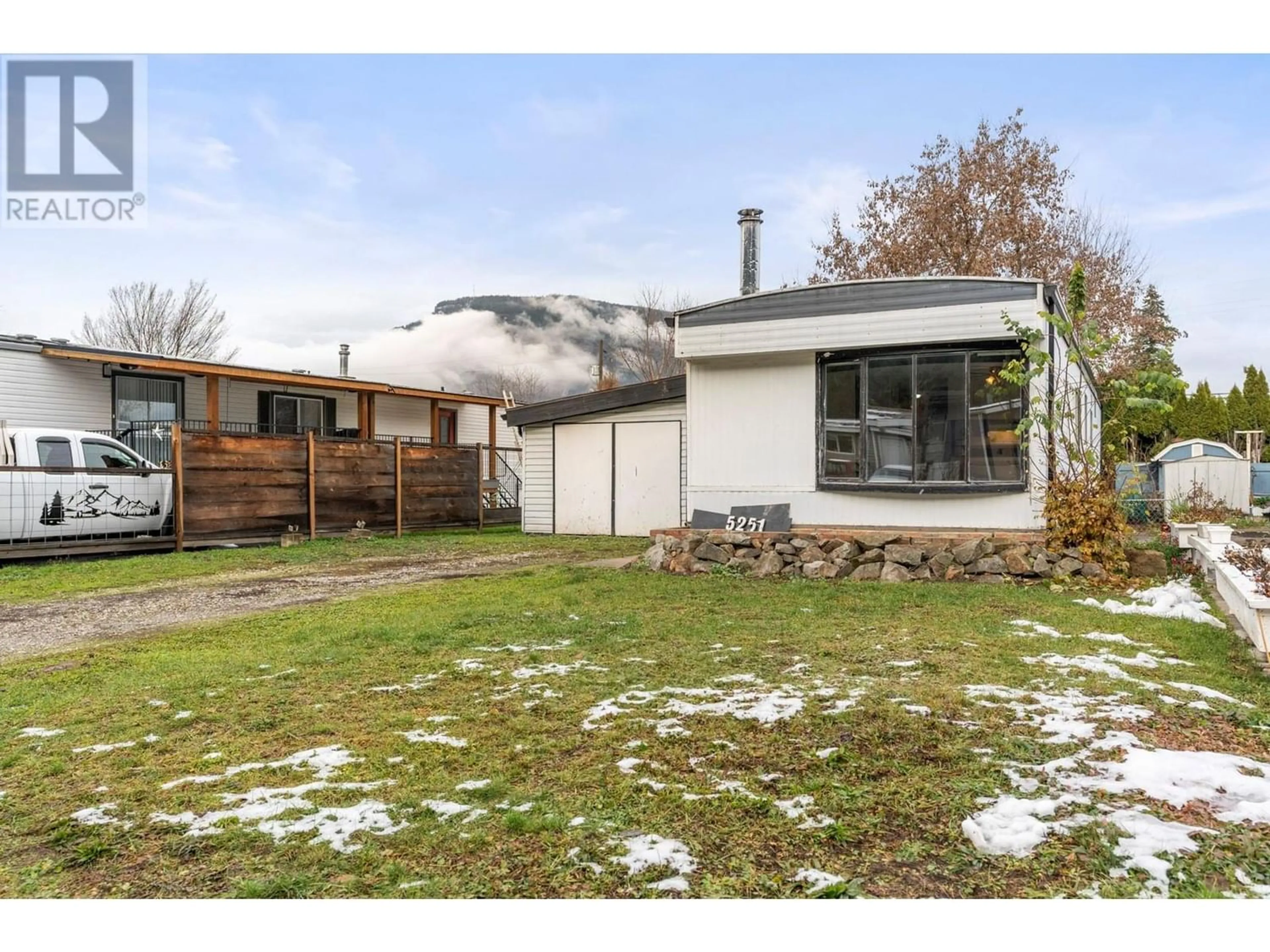 Frontside or backside of a home, the fenced backyard for 5251 69 Avenue, Canoe British Columbia V0E1K0