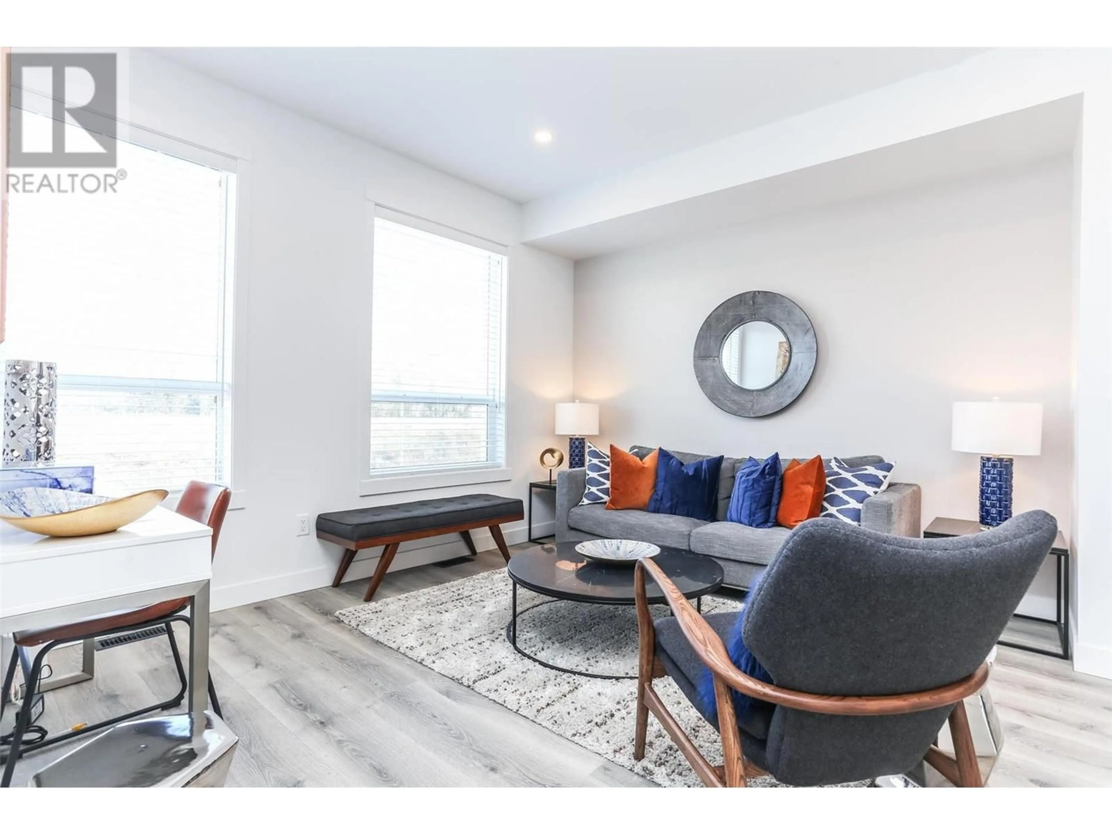 Living room with furniture, wood/laminate floor for 111 - 610 ACADEMY WAY, Kelowna British Columbia V1V0H2