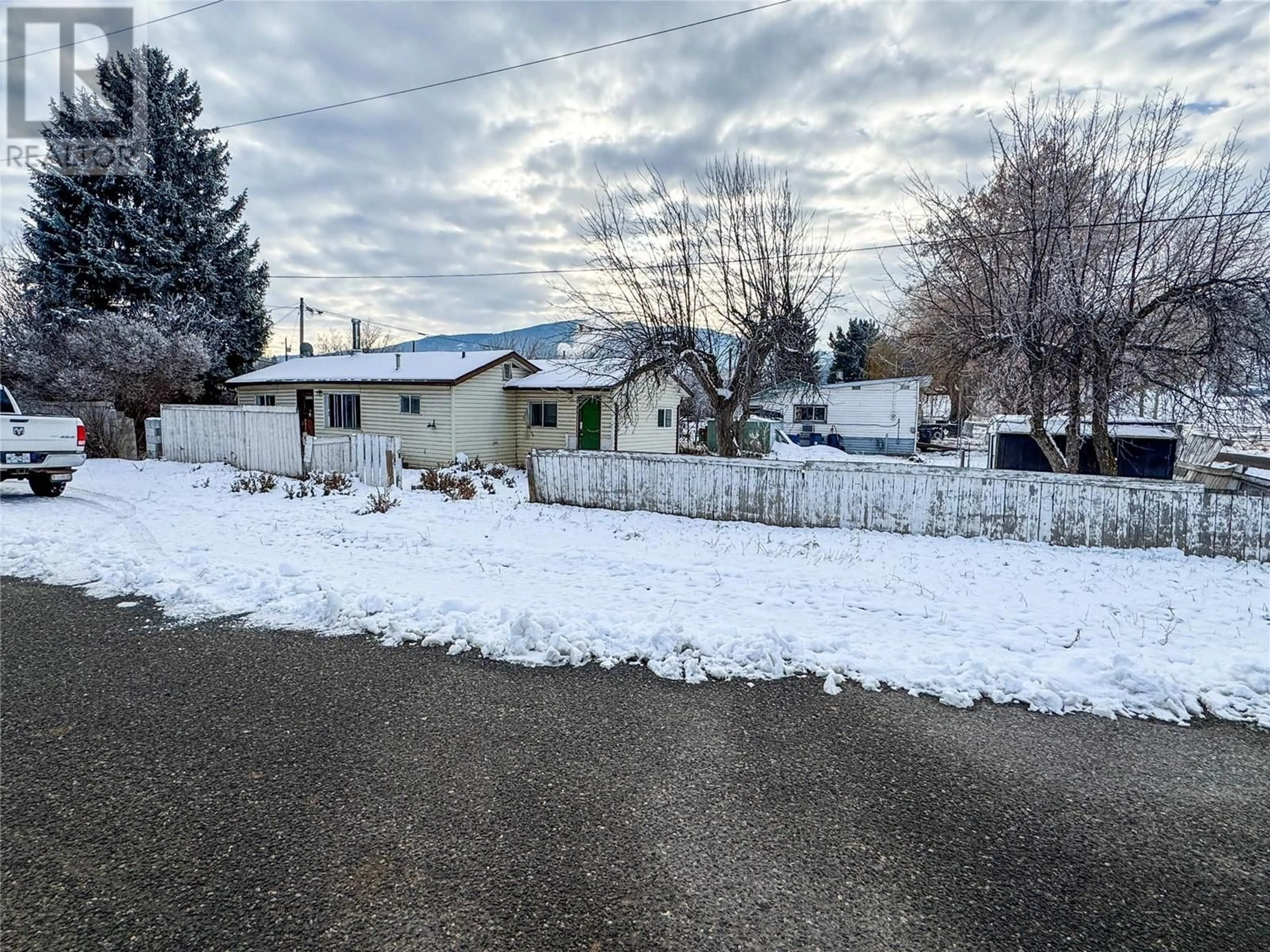 Frontside or backside of a home, the fenced backyard for 1201 Hicks Avenue, Merritt British Columbia V1K1K7