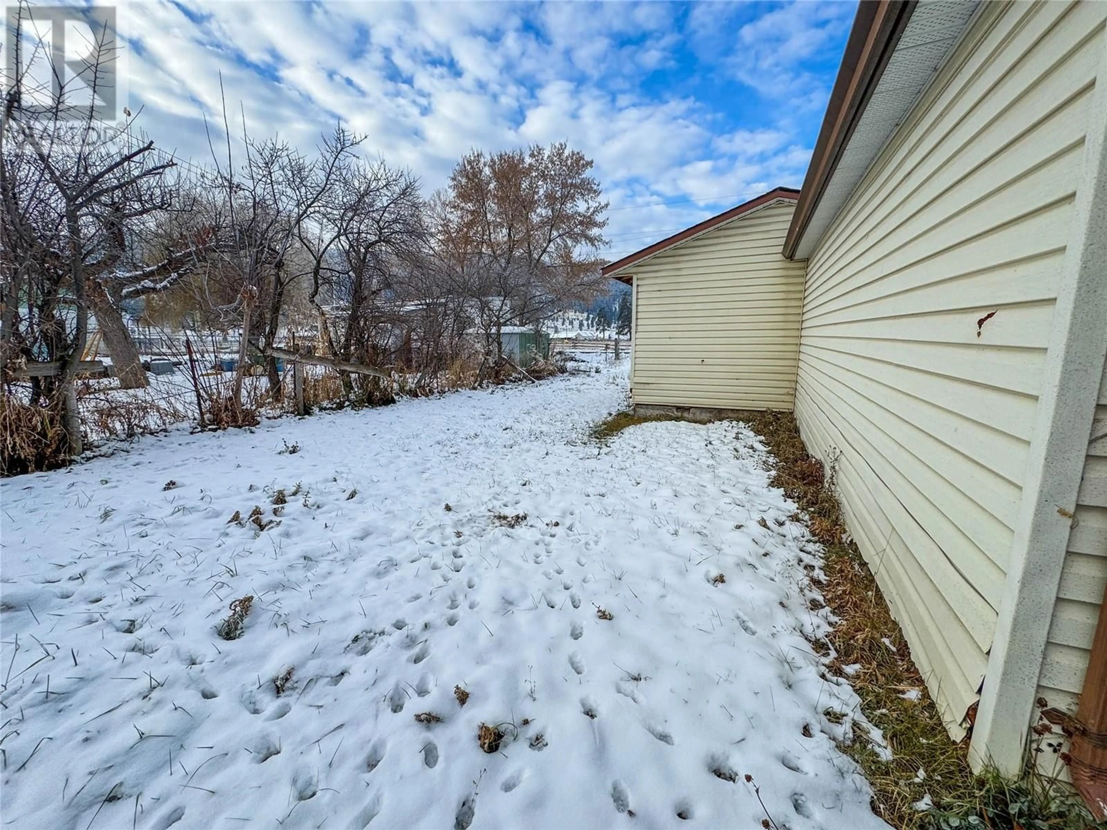 Patio, the fenced backyard for 1201 Hicks Avenue, Merritt British Columbia V1K1K7