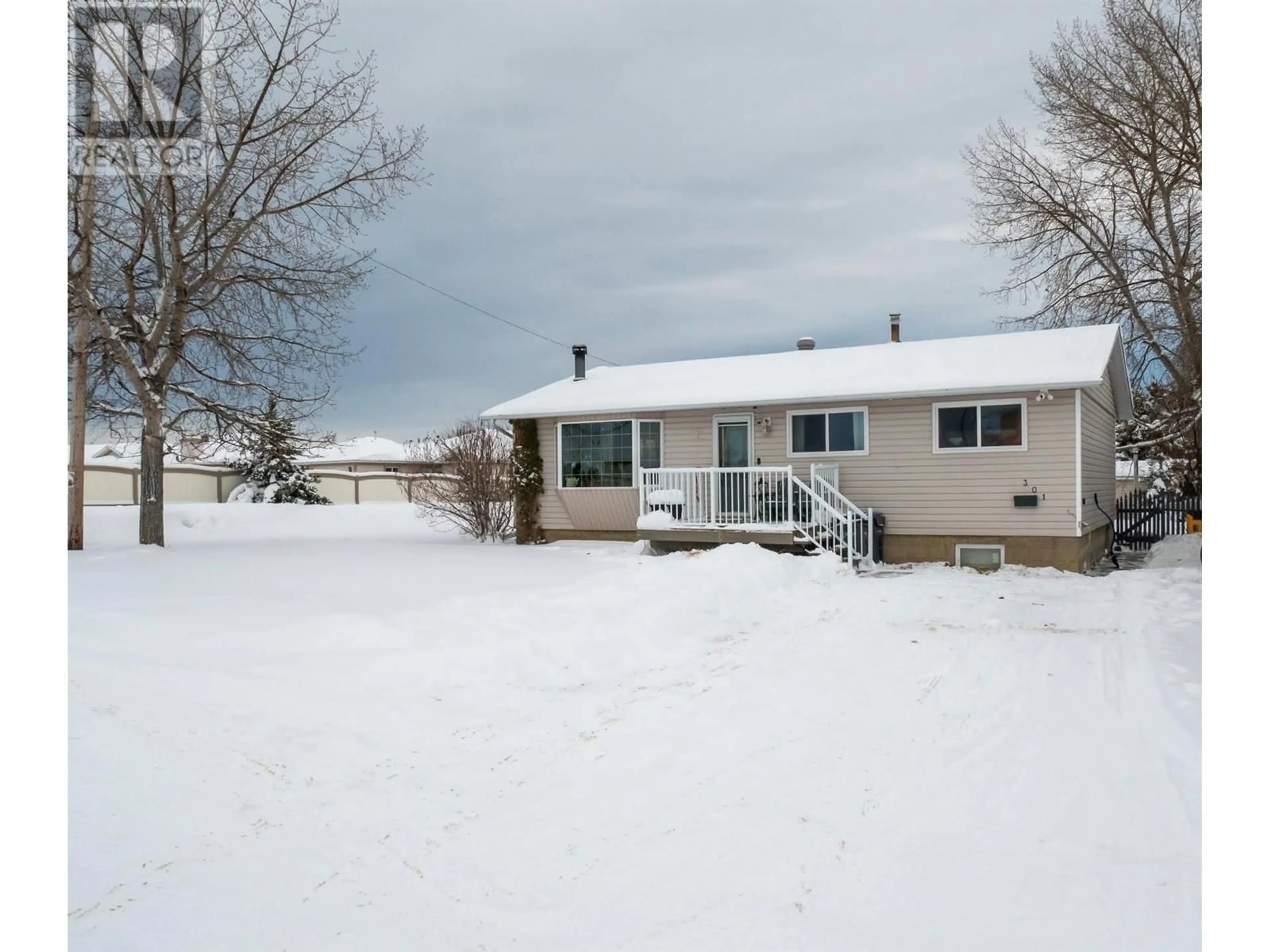 Frontside or backside of a home, the fenced backyard for 301 95 Avenue, Dawson Creek British Columbia V1G1H4