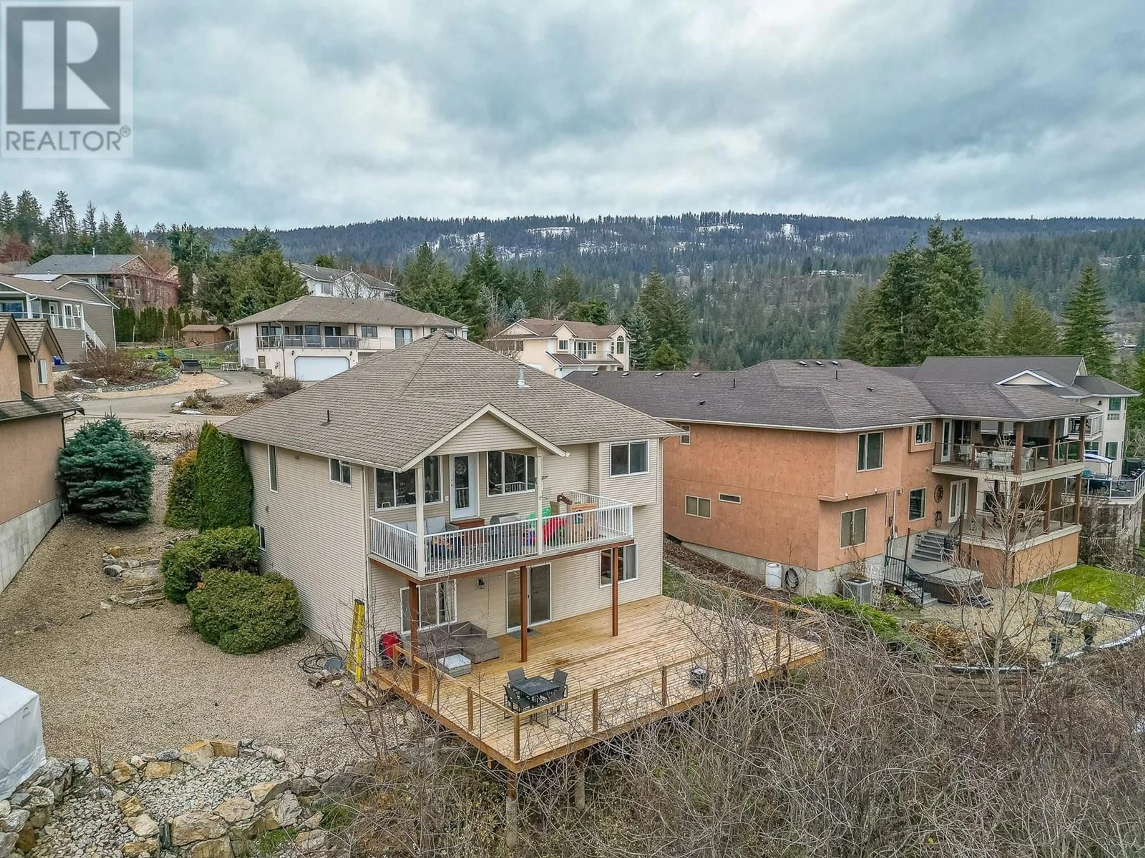 Frontside or backside of a home, the fenced backyard for 110 Red Rock Crescent, Enderby British Columbia V0E1V1