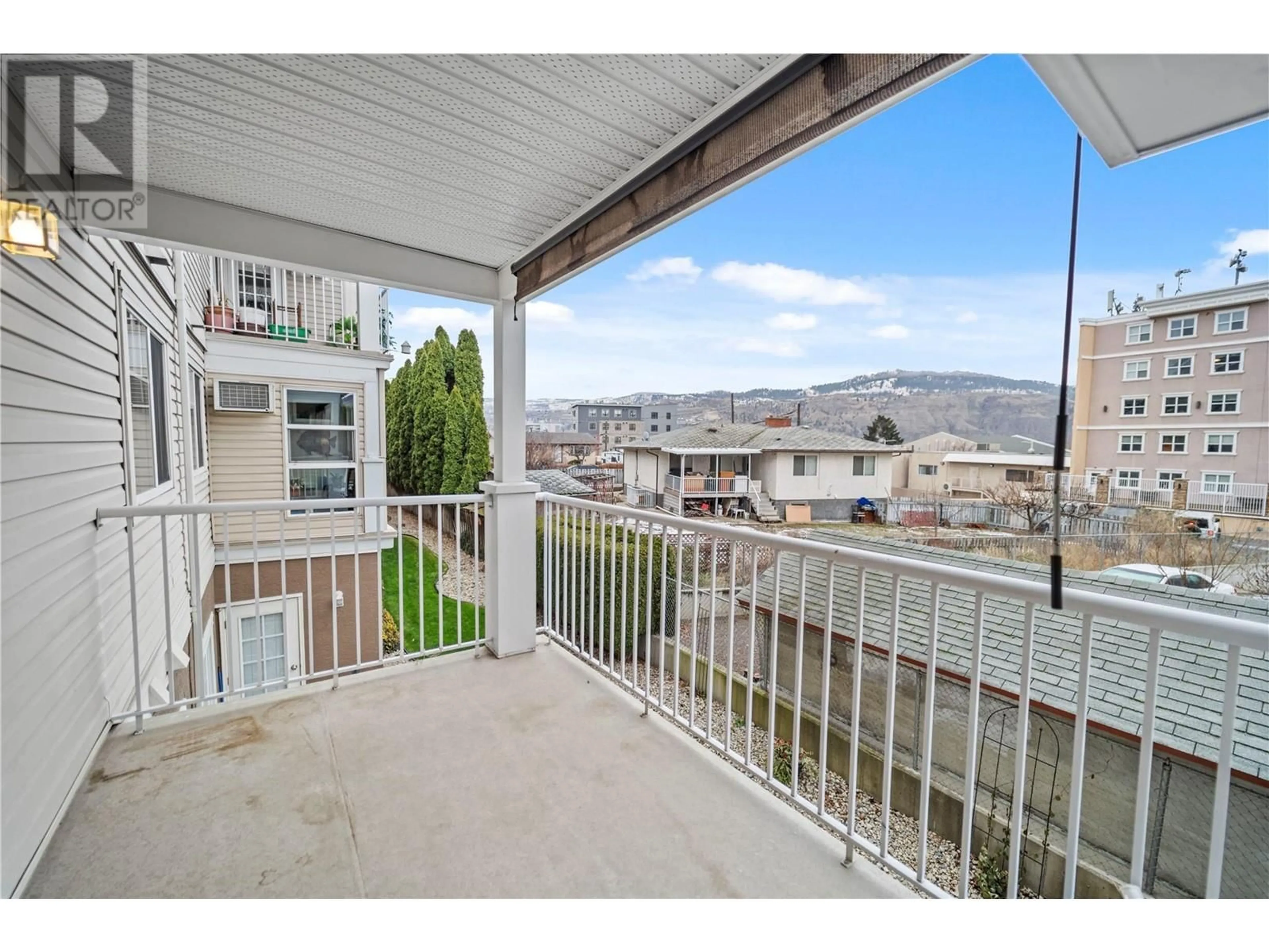 A pic from exterior of the house or condo, the fenced backyard for 120 Vernon Avenue Unit# 204, Kamloops British Columbia V2B1L6