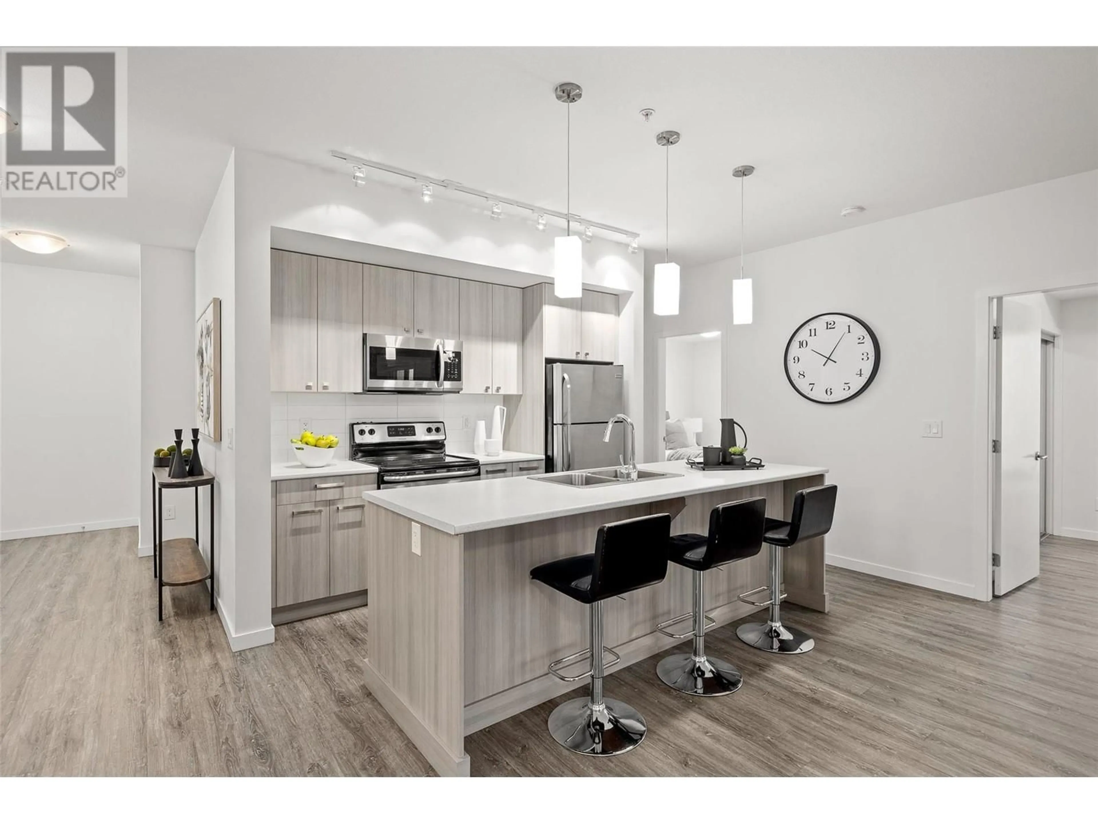 Open concept kitchen, wood/laminate floor for 935 Academy Way Unit# 212, Kelowna British Columbia V1V3C8