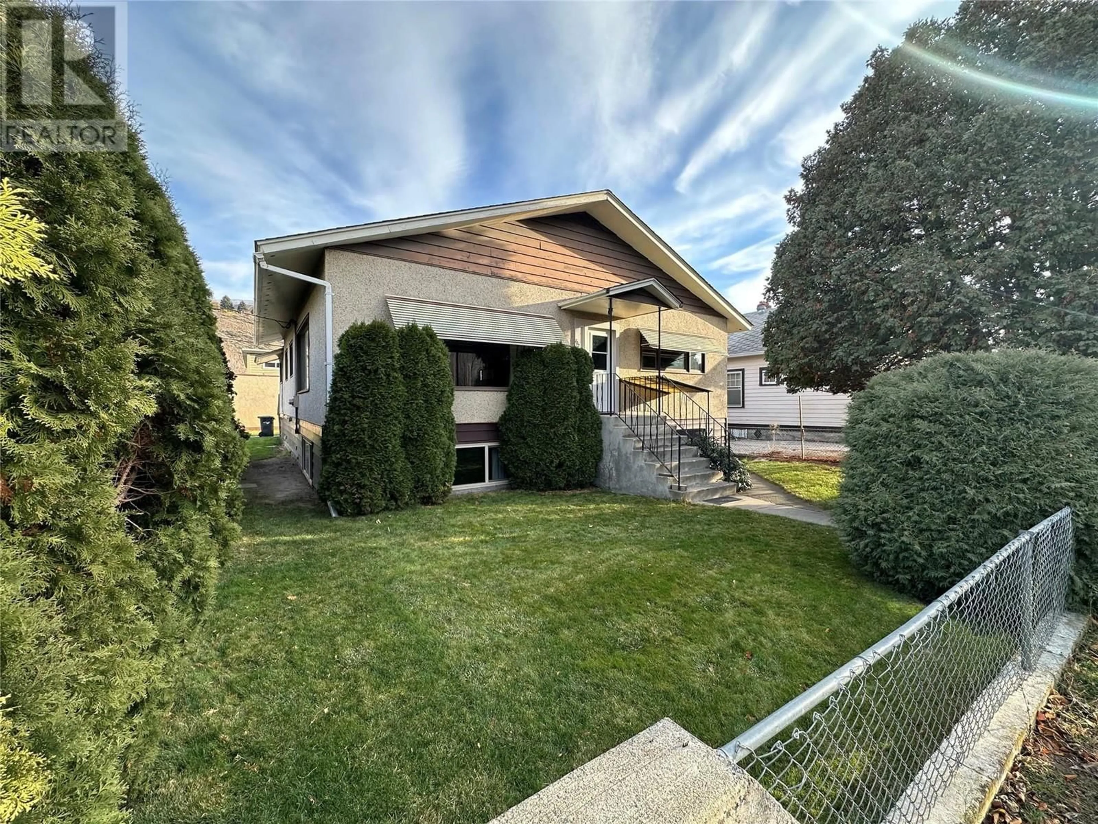 Frontside or backside of a home, the fenced backyard for 702 Brink Street, Ashcroft British Columbia V0K1A0