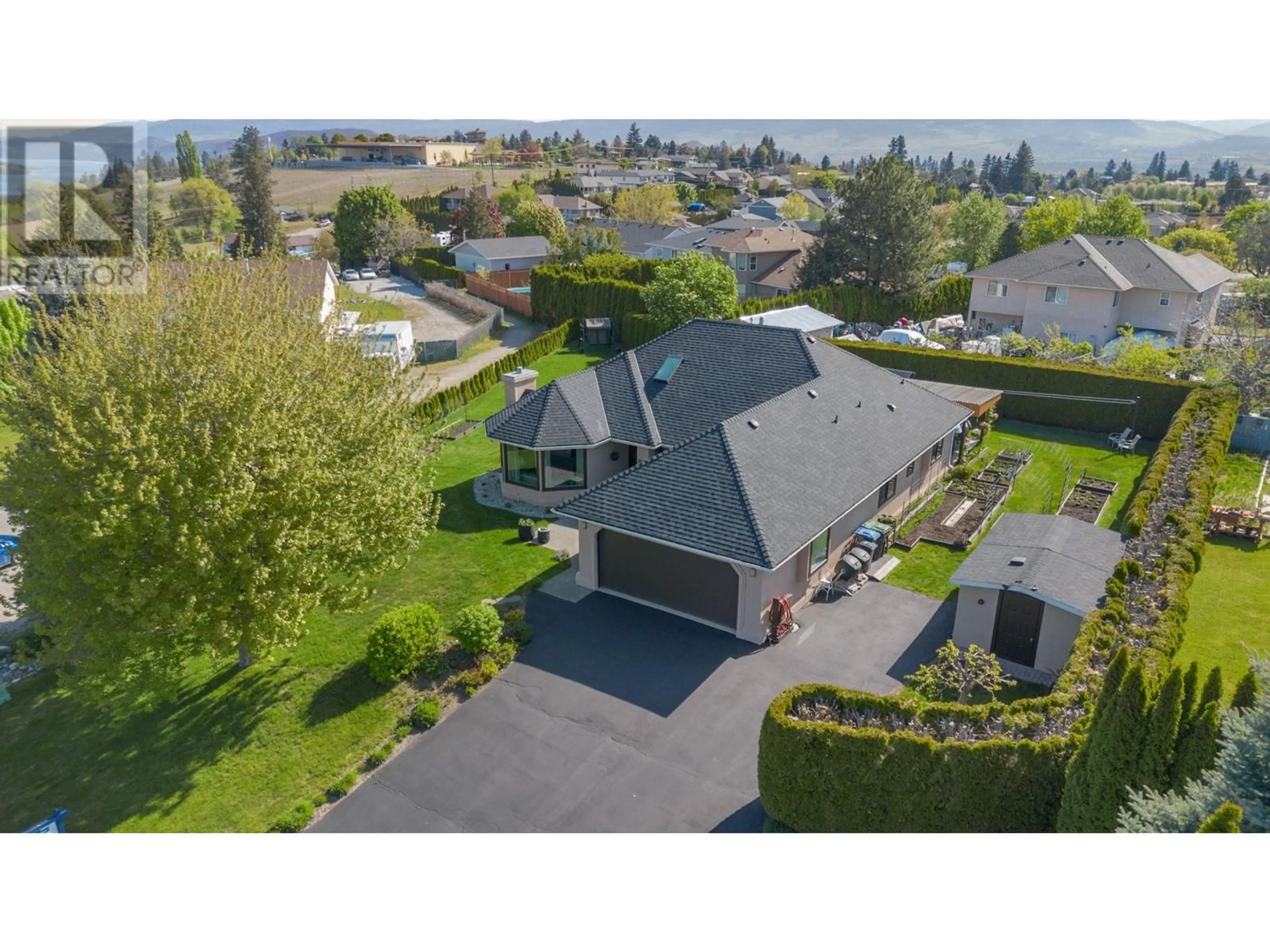 Frontside or backside of a home, the fenced backyard for 2663 Paula Road, West Kelowna British Columbia V1Z3L7