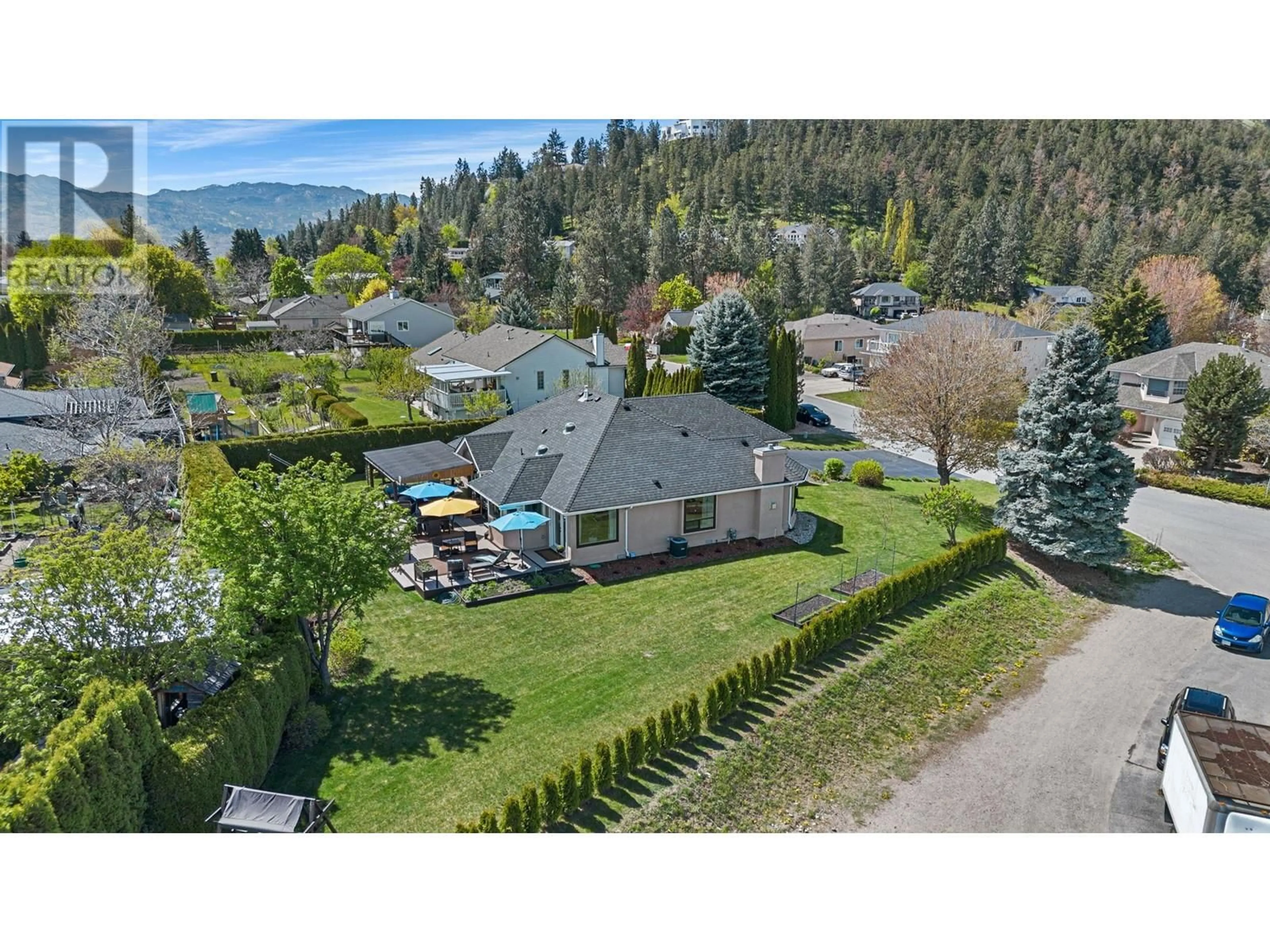 Frontside or backside of a home, the fenced backyard for 2663 Paula Road, West Kelowna British Columbia V1Z3L7