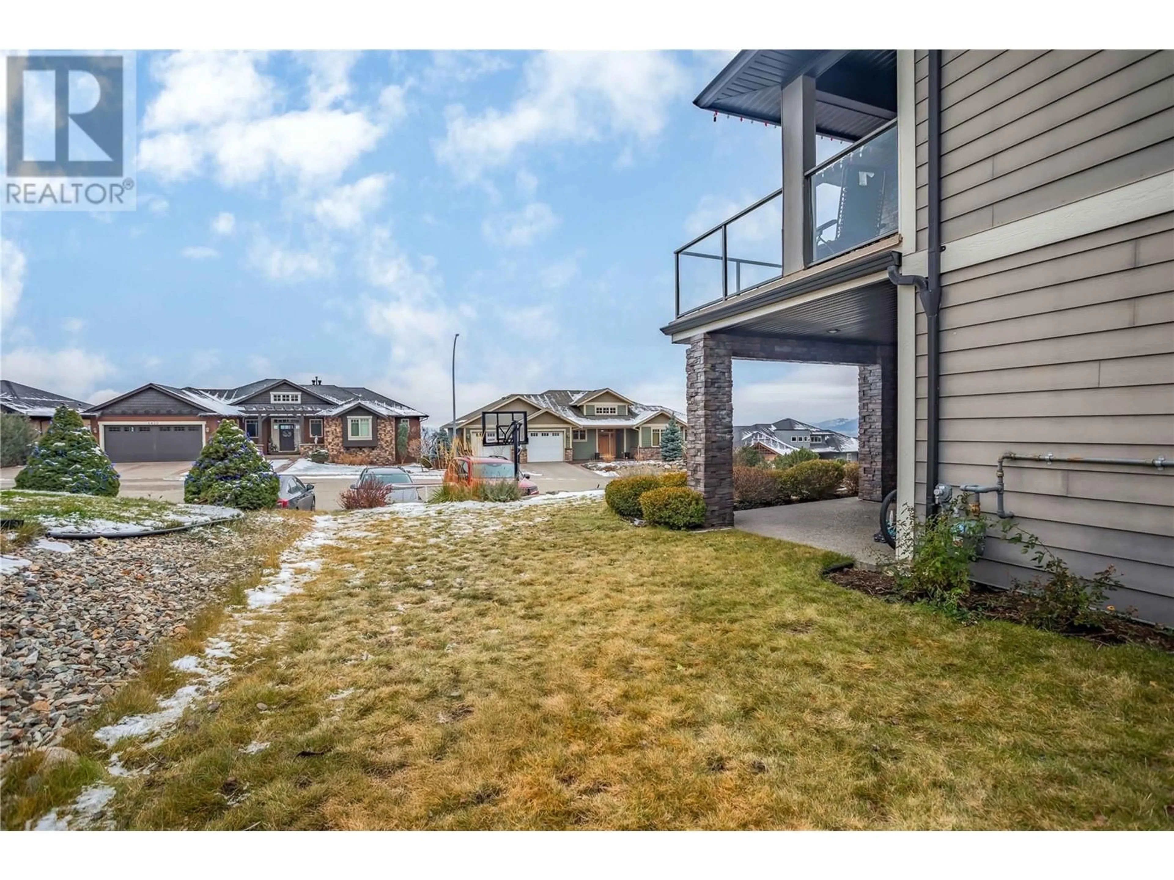 Frontside or backside of a home, the fenced backyard for 1425 Red Mountain Place, Vernon British Columbia V1B4A3