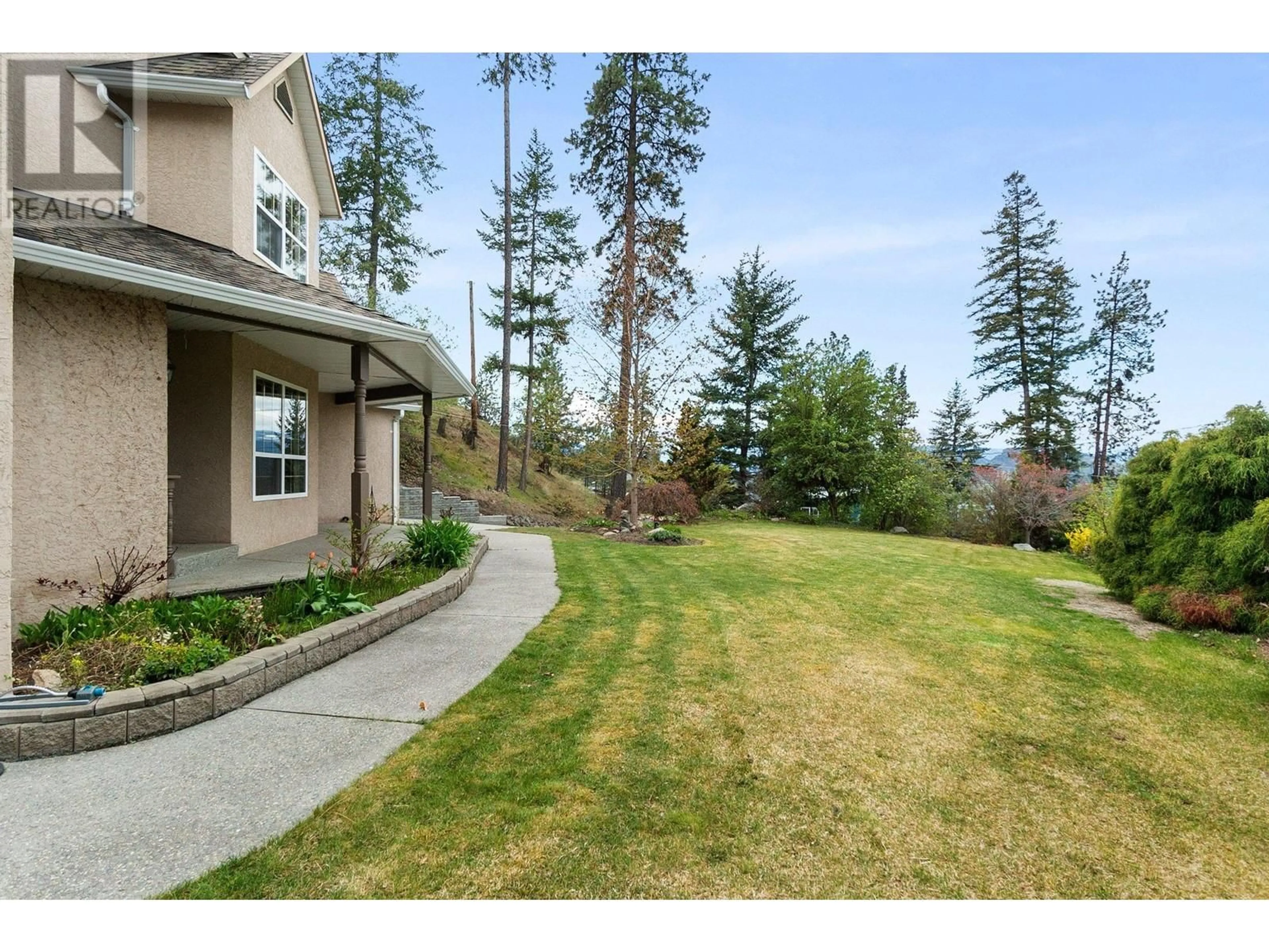 Frontside or backside of a home, the fenced backyard for 3281 Juniper Drive, Naramata British Columbia V0H1N1