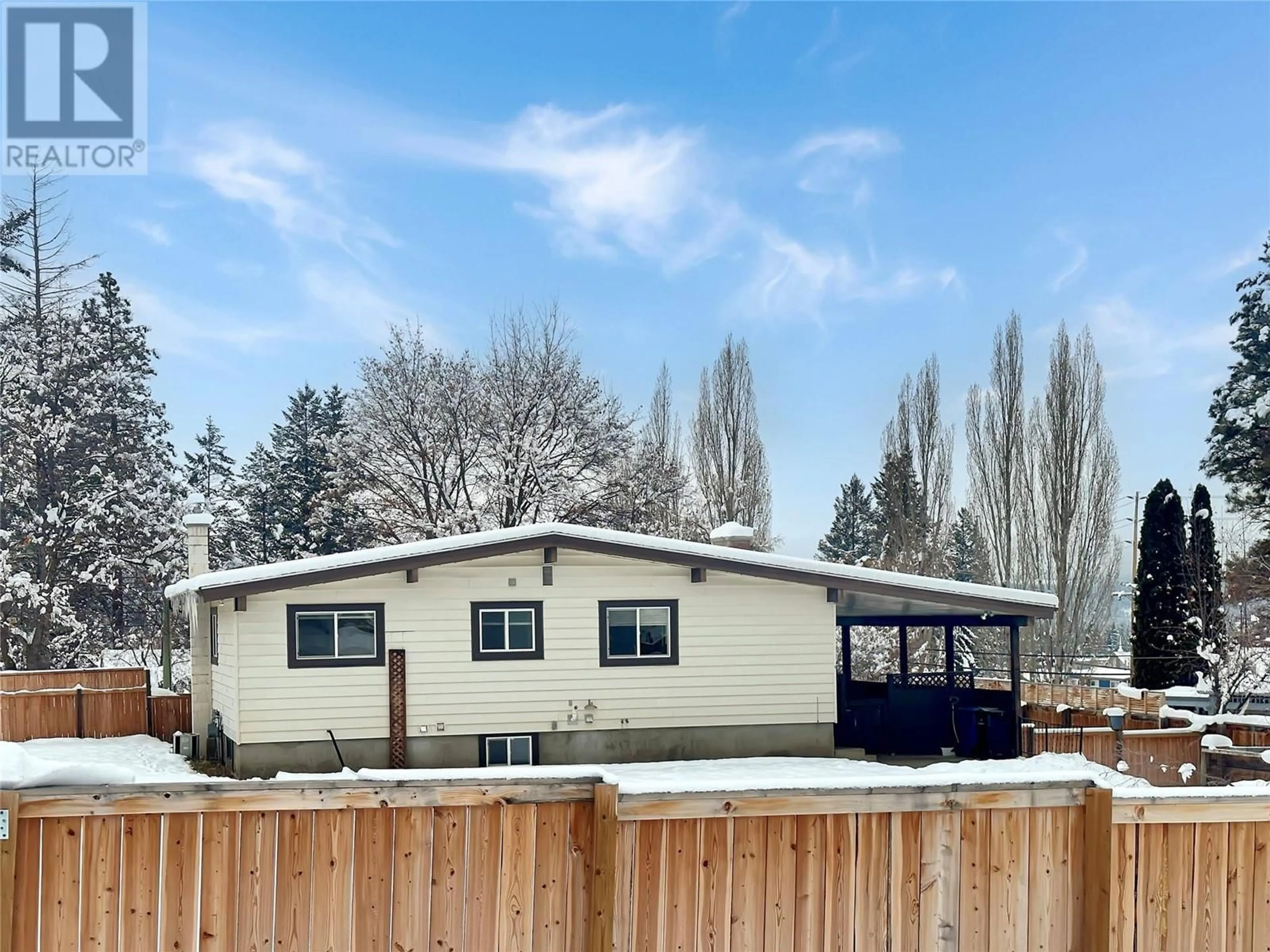 Frontside or backside of a home, the fenced backyard for 310 27 A Avenue S, Cranbrook British Columbia V1C3J7