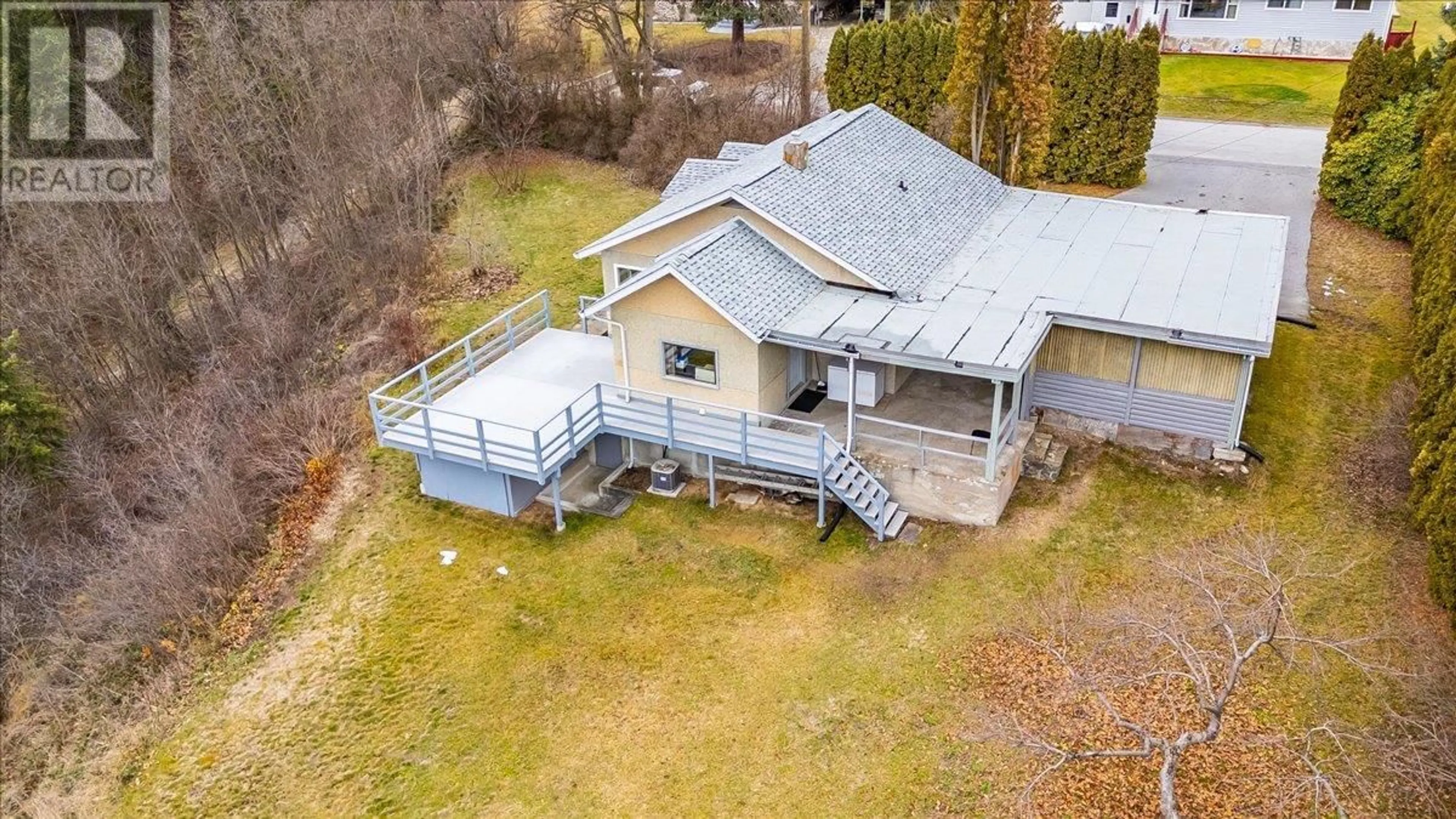 Frontside or backside of a home, the fenced backyard for 3601 3rd Avenue, Castlegar British Columbia V1N2R7