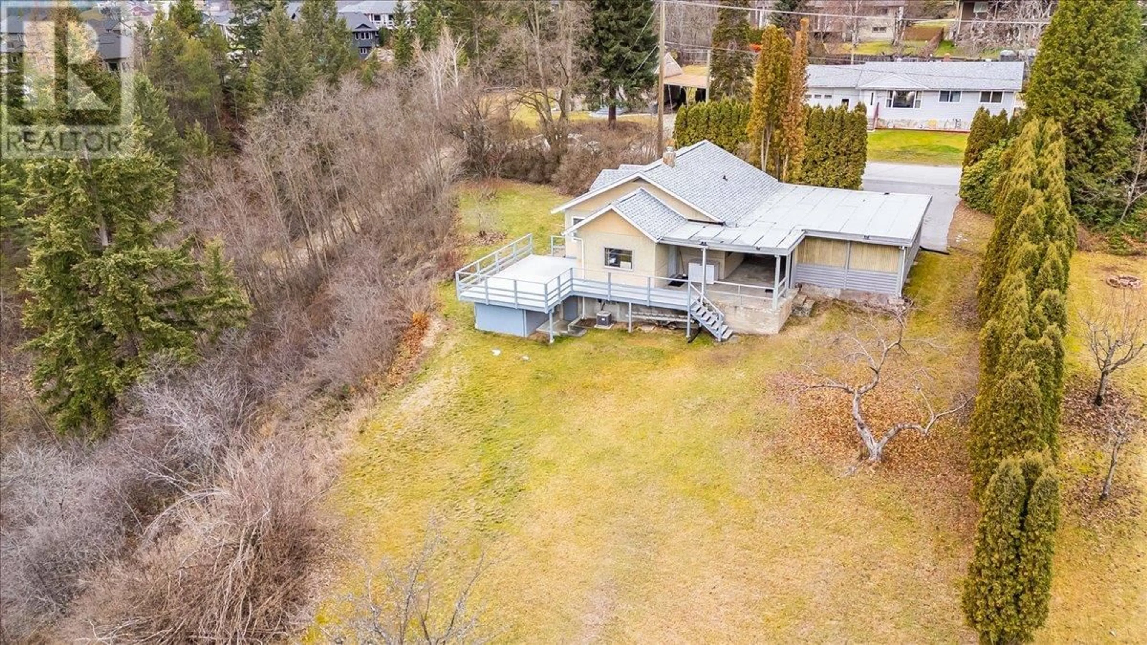 Frontside or backside of a home, the fenced backyard for 3601 3rd Avenue, Castlegar British Columbia V1N2R7