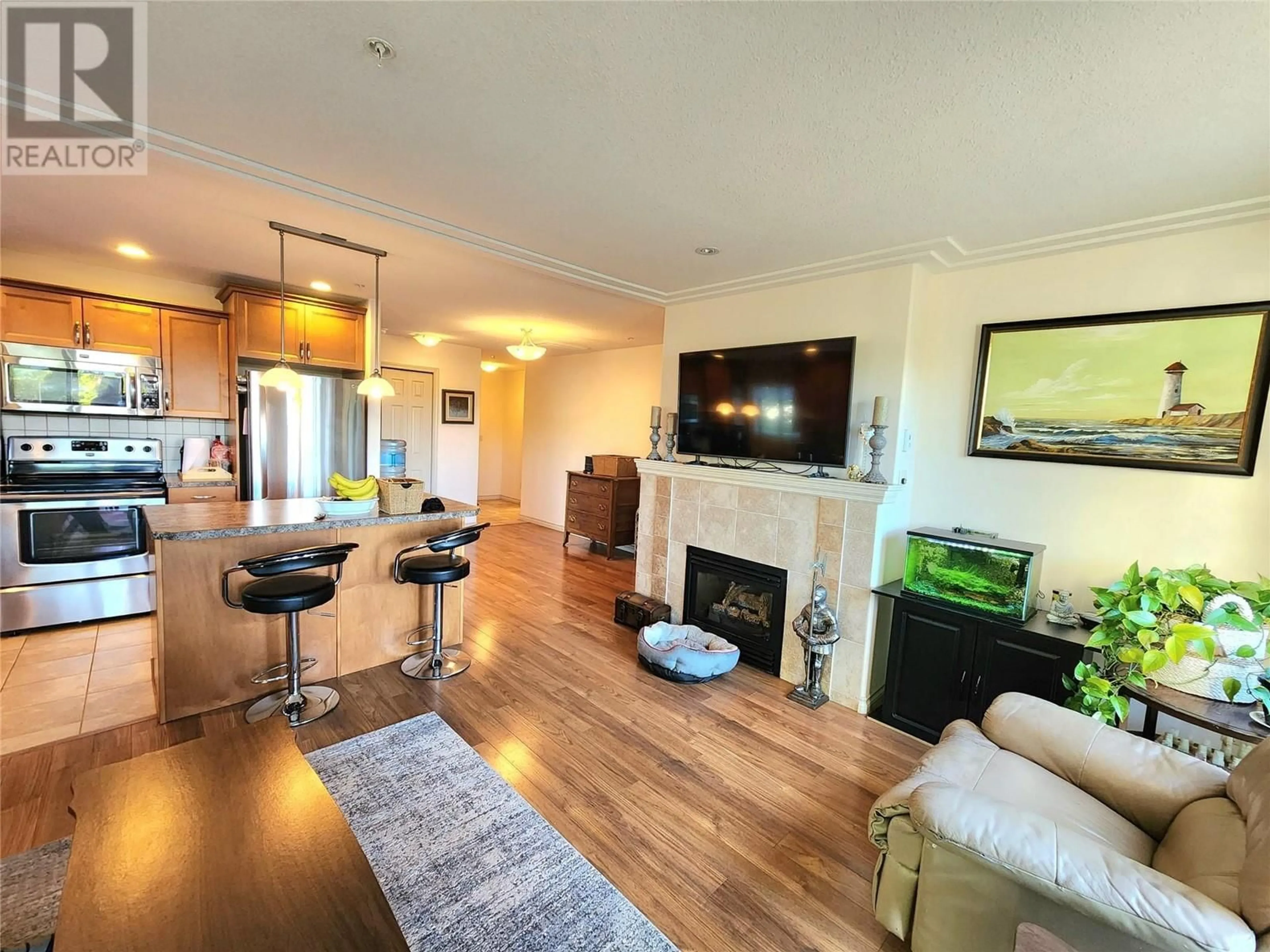 Living room with furniture, wood/laminate floor for 302 - 2125 ATKINSON STREET, Penticton British Columbia V2A9E6