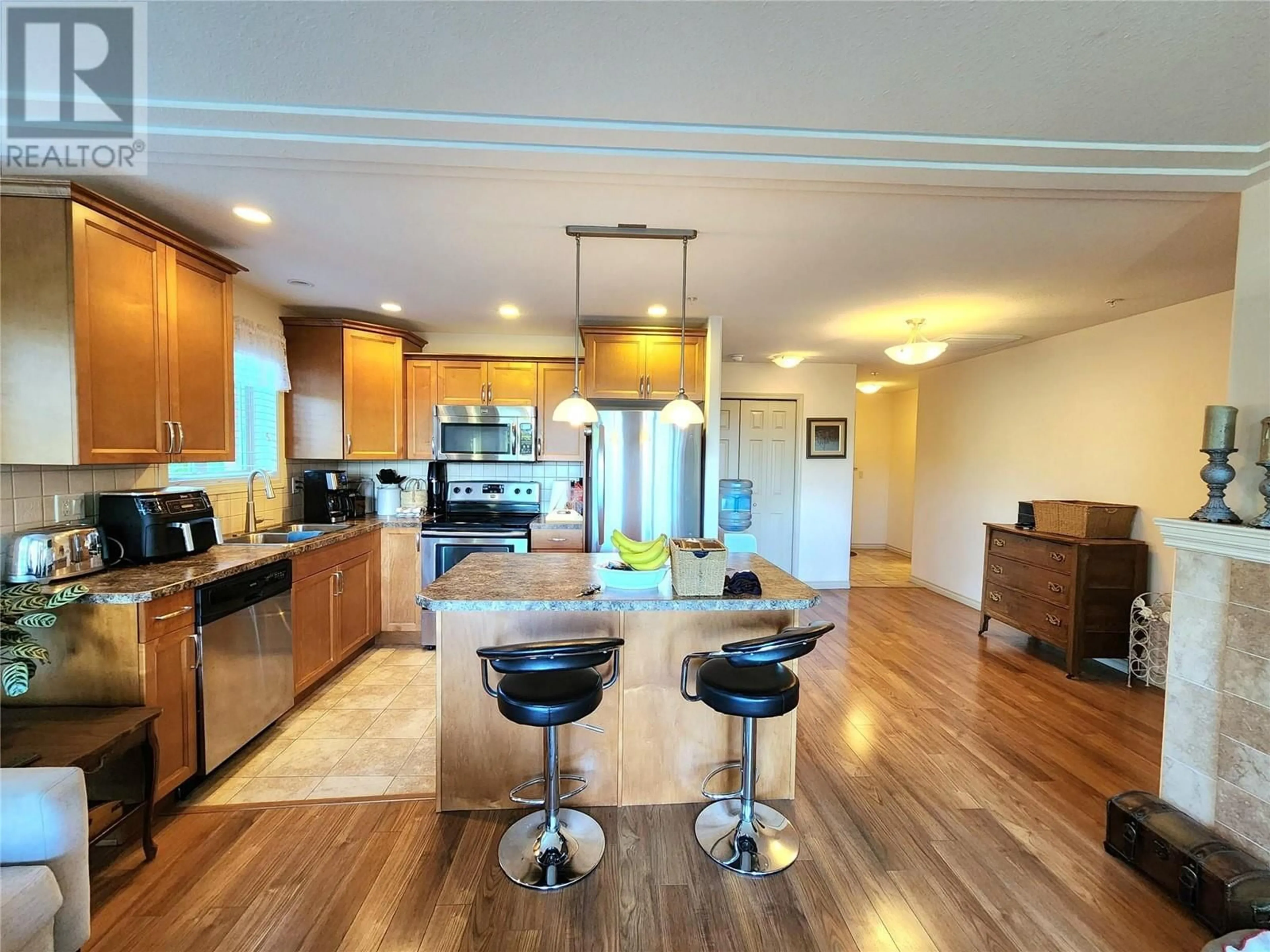 Open concept kitchen, wood/laminate floor for 302 - 2125 ATKINSON STREET, Penticton British Columbia V2A9E6