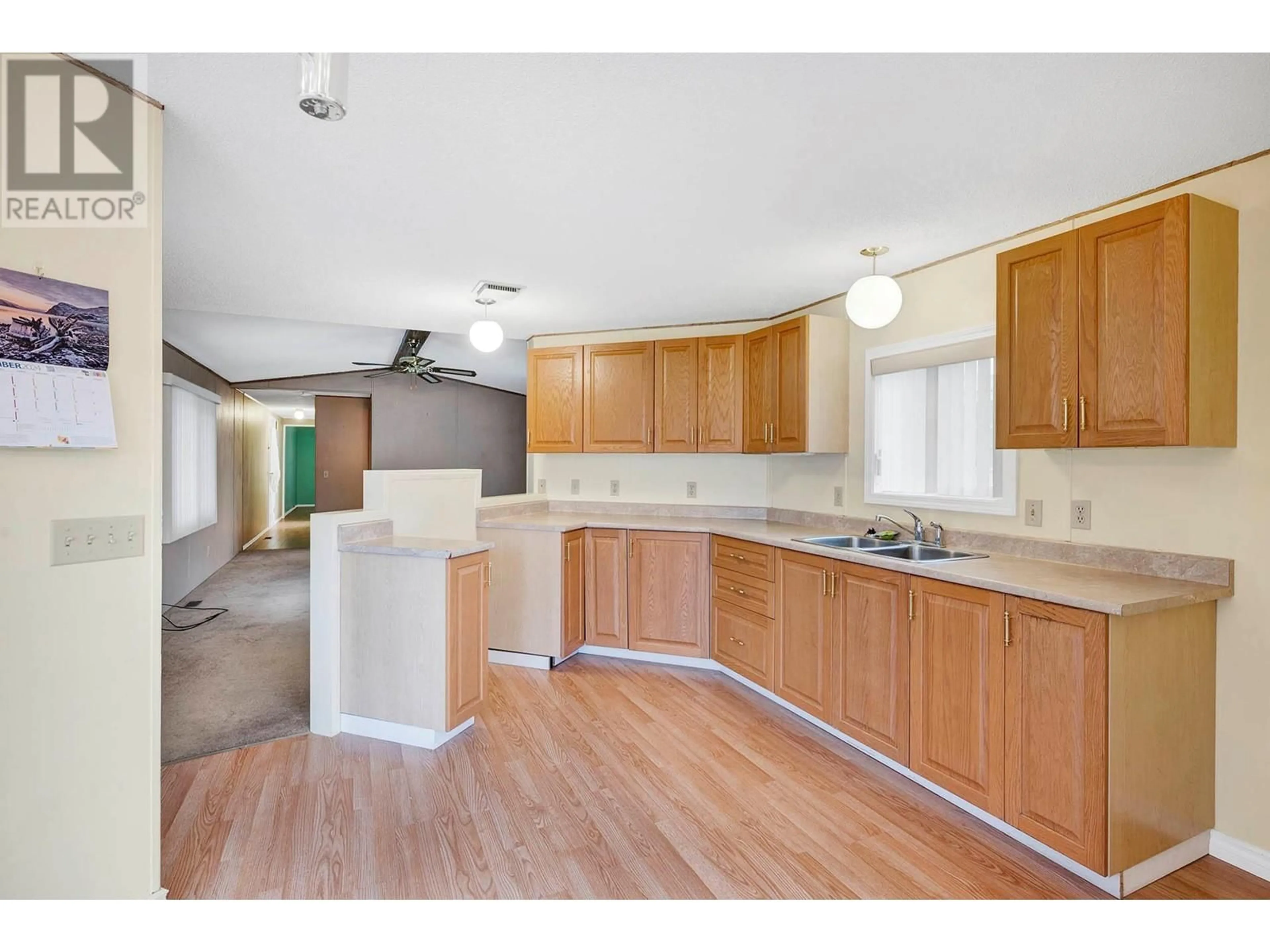 Open concept kitchen, wood/laminate floor for 213U - 213 UNIVERSAL WAY, Kamloops British Columbia V2B1A5