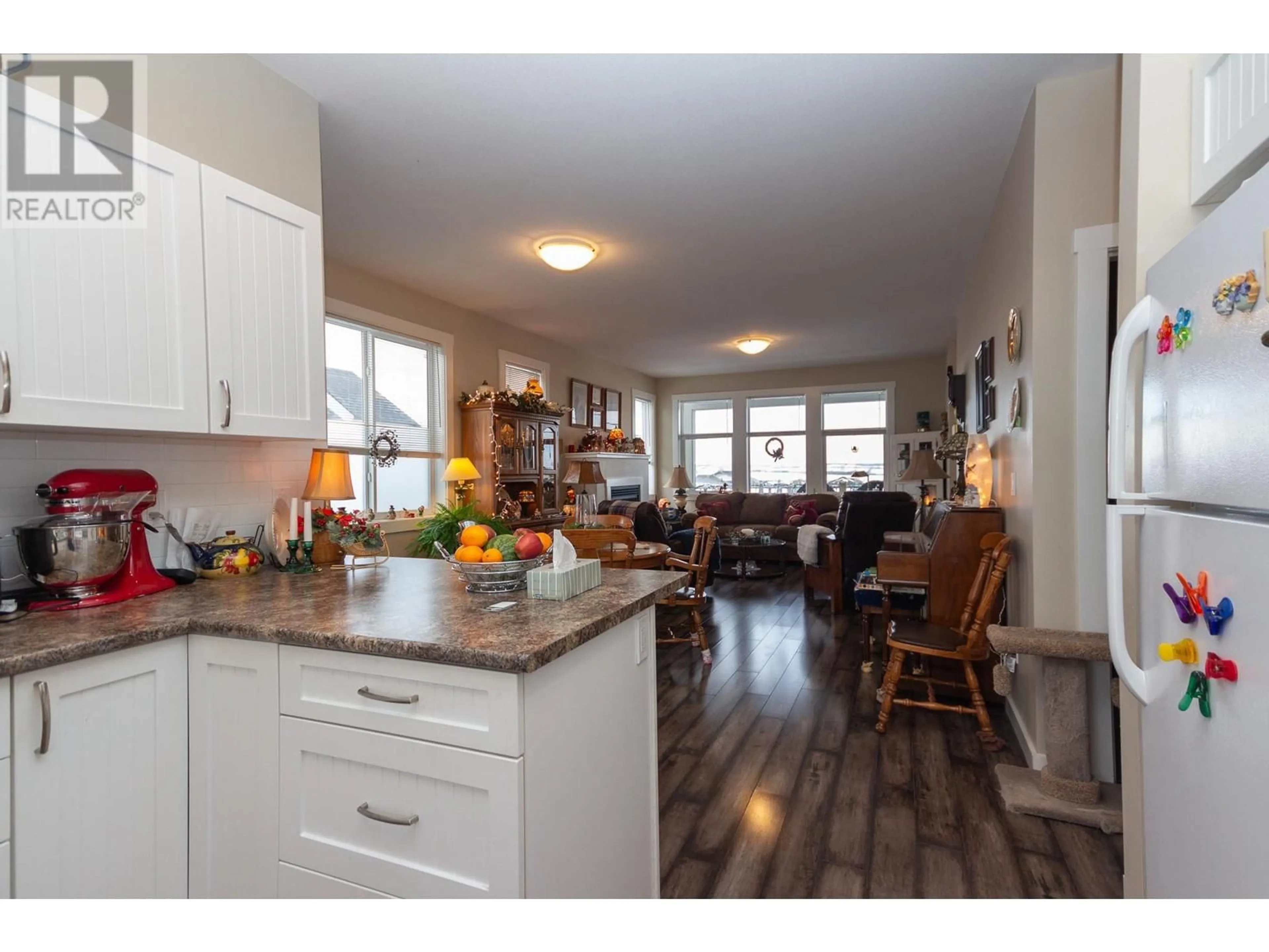 Open concept kitchen, wood/laminate floor for 8804 17 Street, Dawson Creek British Columbia V1G0H2