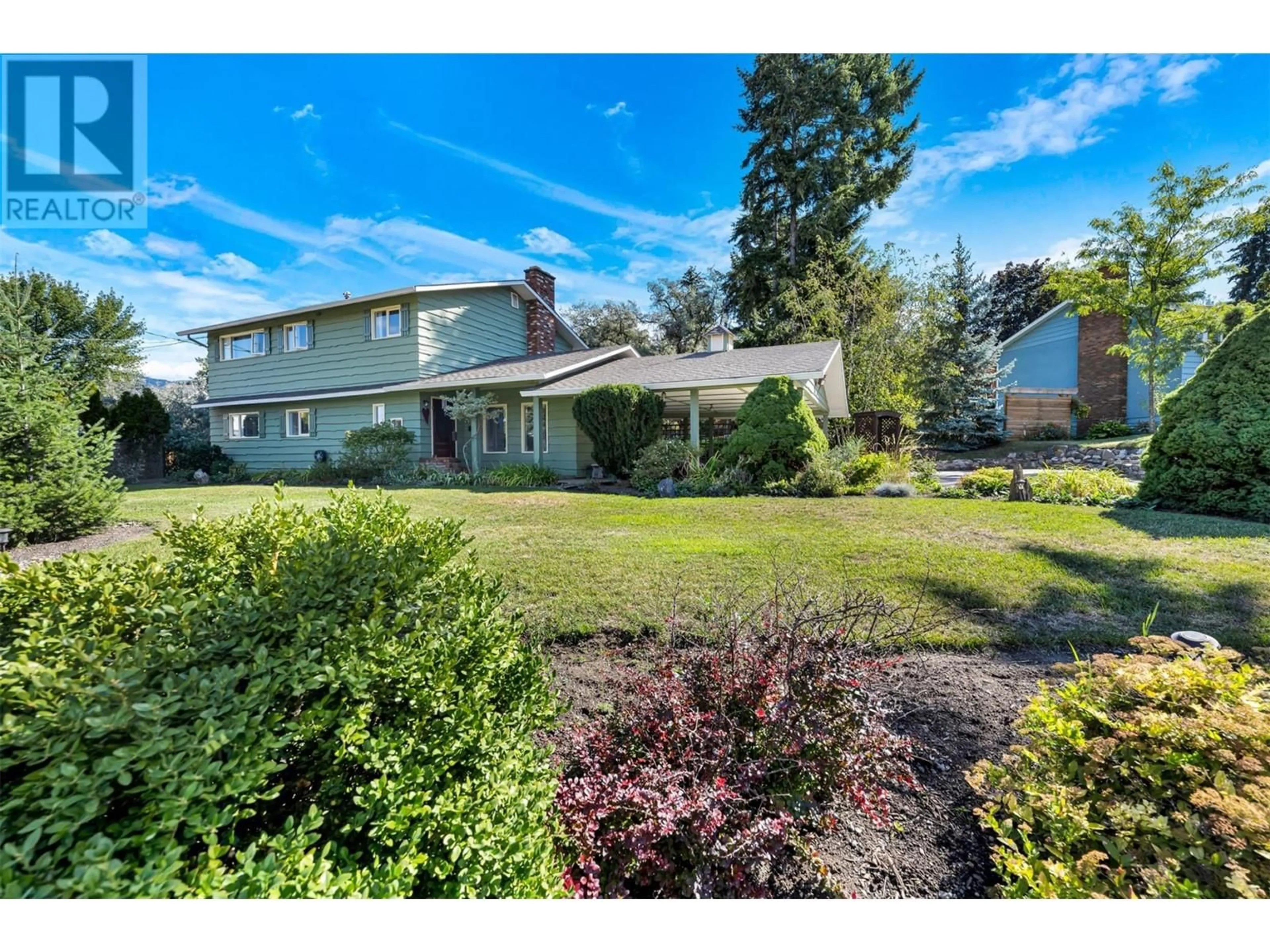 A pic from outside/outdoor area/front of a property/back of a property/a pic from drone, street for 7701 Holtam Drive, Coldstream British Columbia V1B1T5