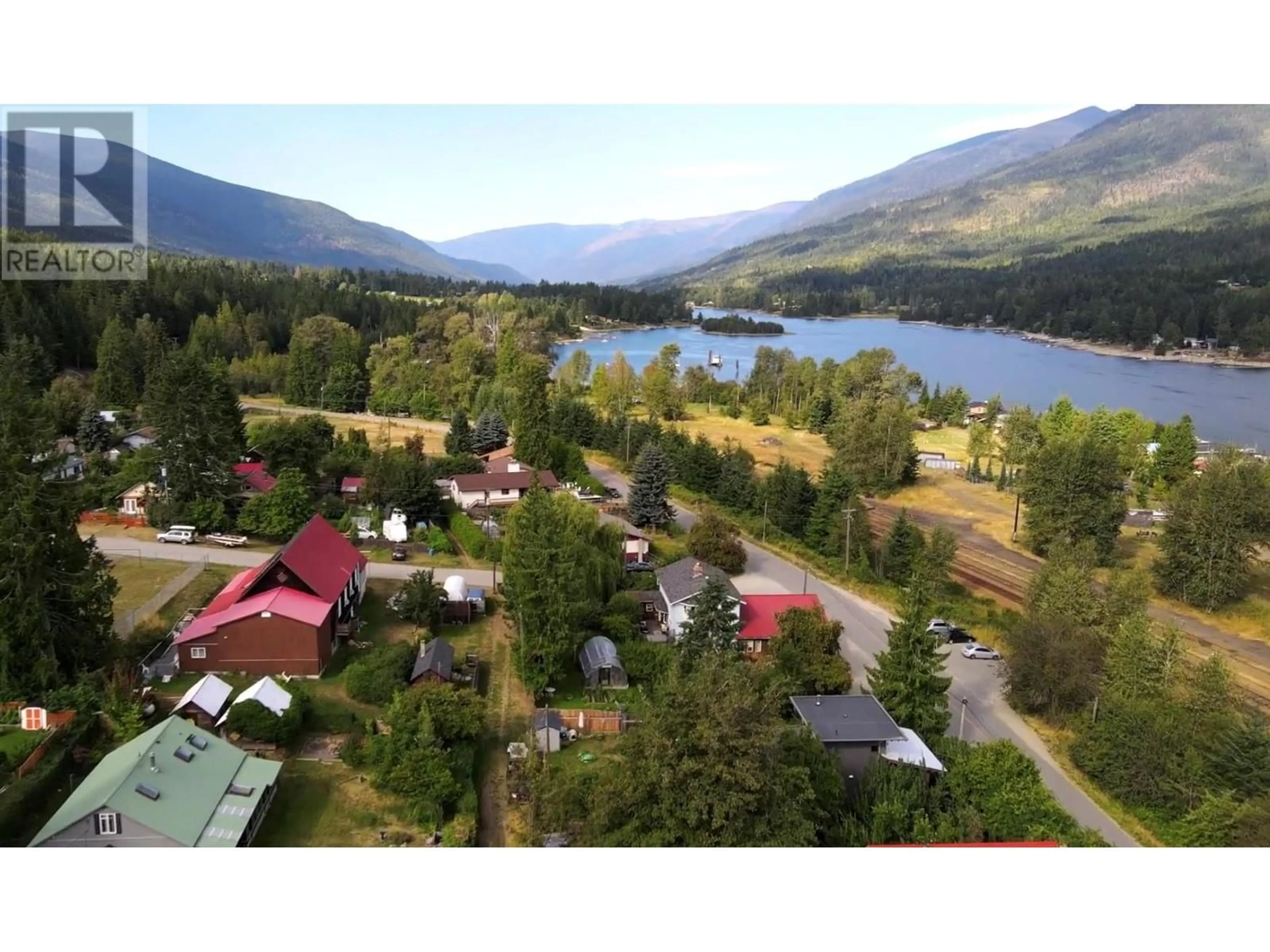 A pic from outside/outdoor area/front of a property/back of a property/a pic from drone, mountain view for 7904 Railway Avenue Avenue, Procter British Columbia V1L0B7