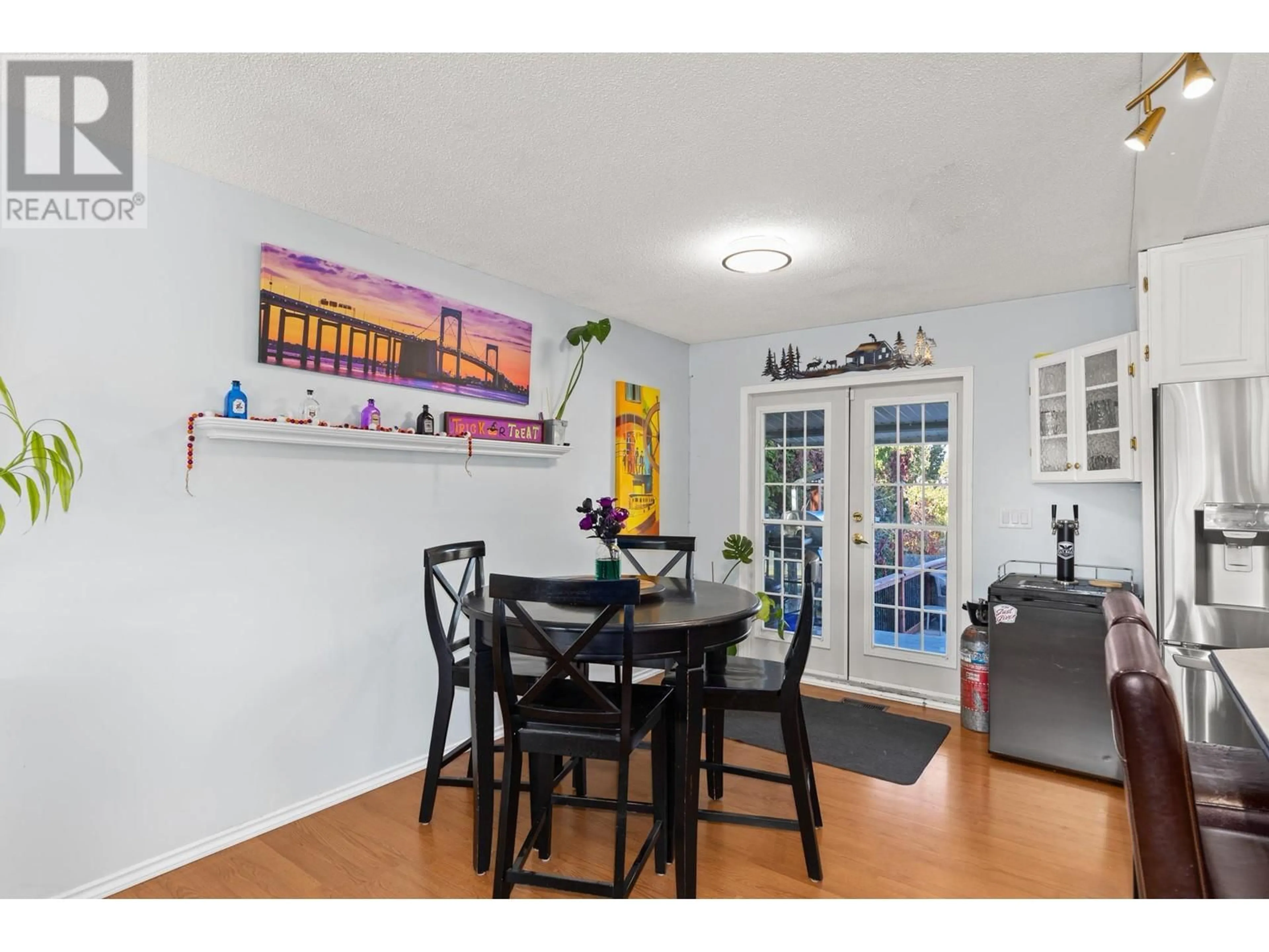 Dining room, wood/laminate floor for 310 Pearson Road, Kelowna British Columbia V1X2L6