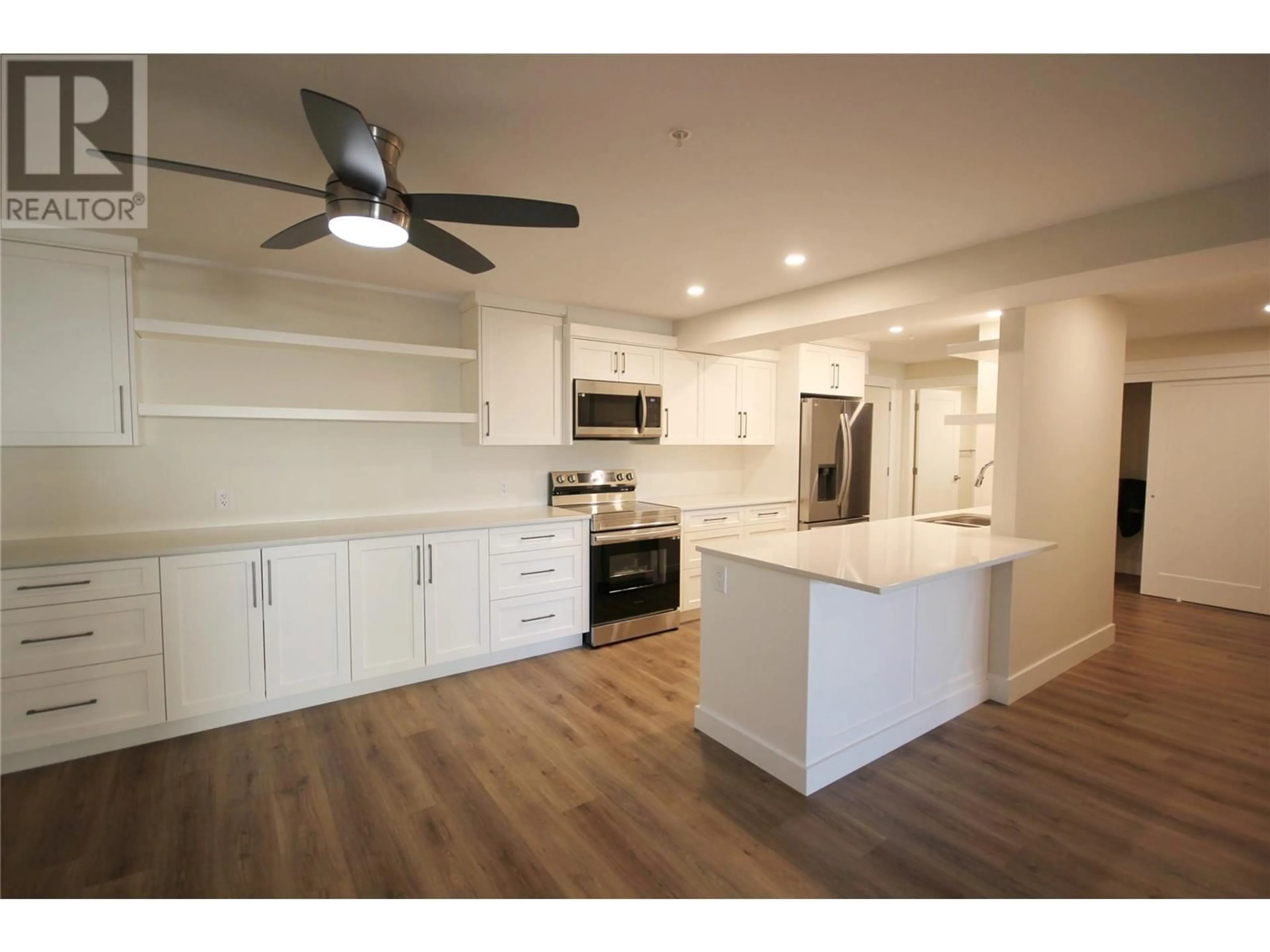 Open concept kitchen, wood/laminate floor for 217 Elm Avenue Unit# 209, Penticton British Columbia V2A3W1