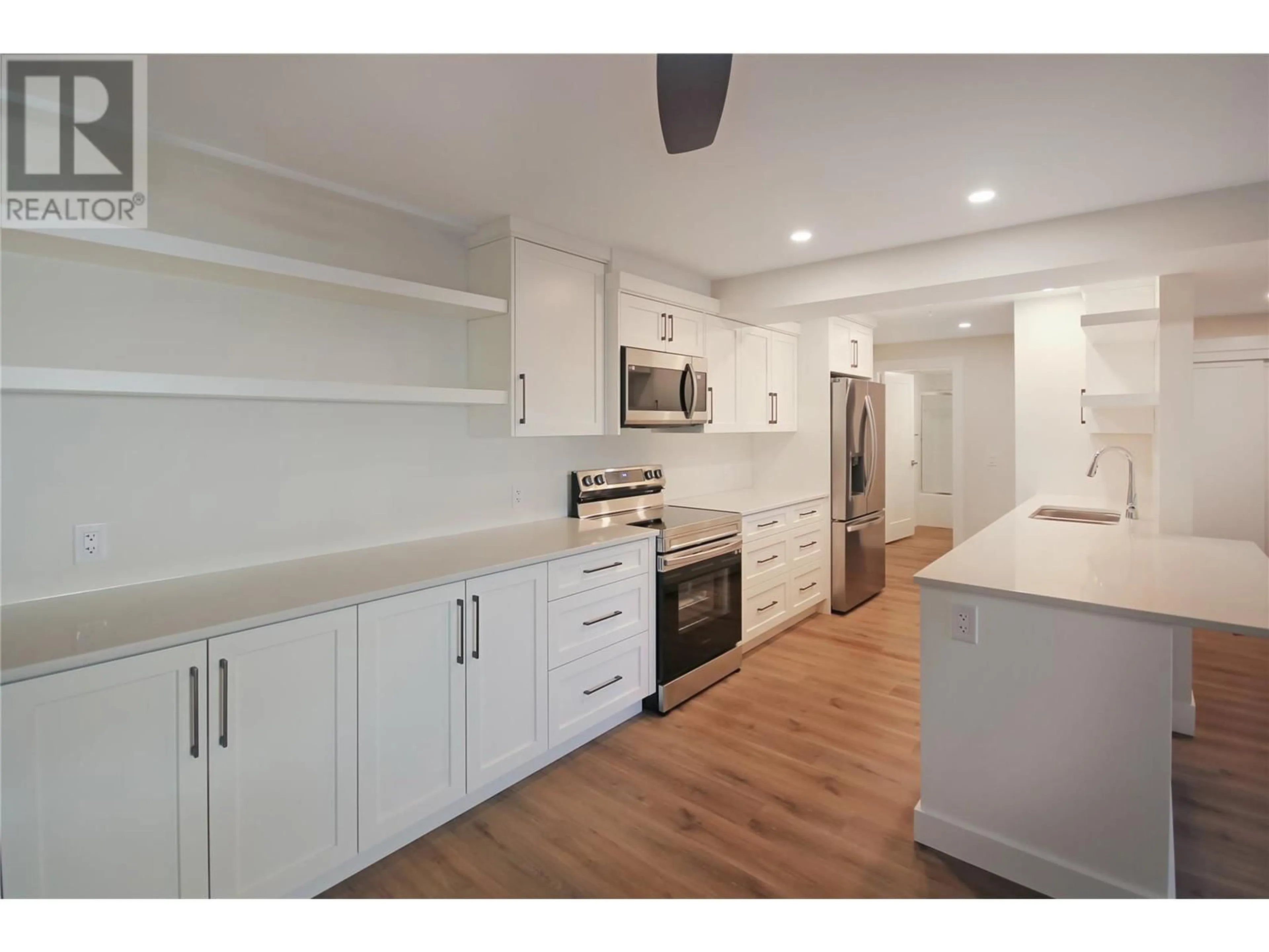 Open concept kitchen, wood/laminate floor for 217 Elm Avenue Unit# 209, Penticton British Columbia V2A3W1