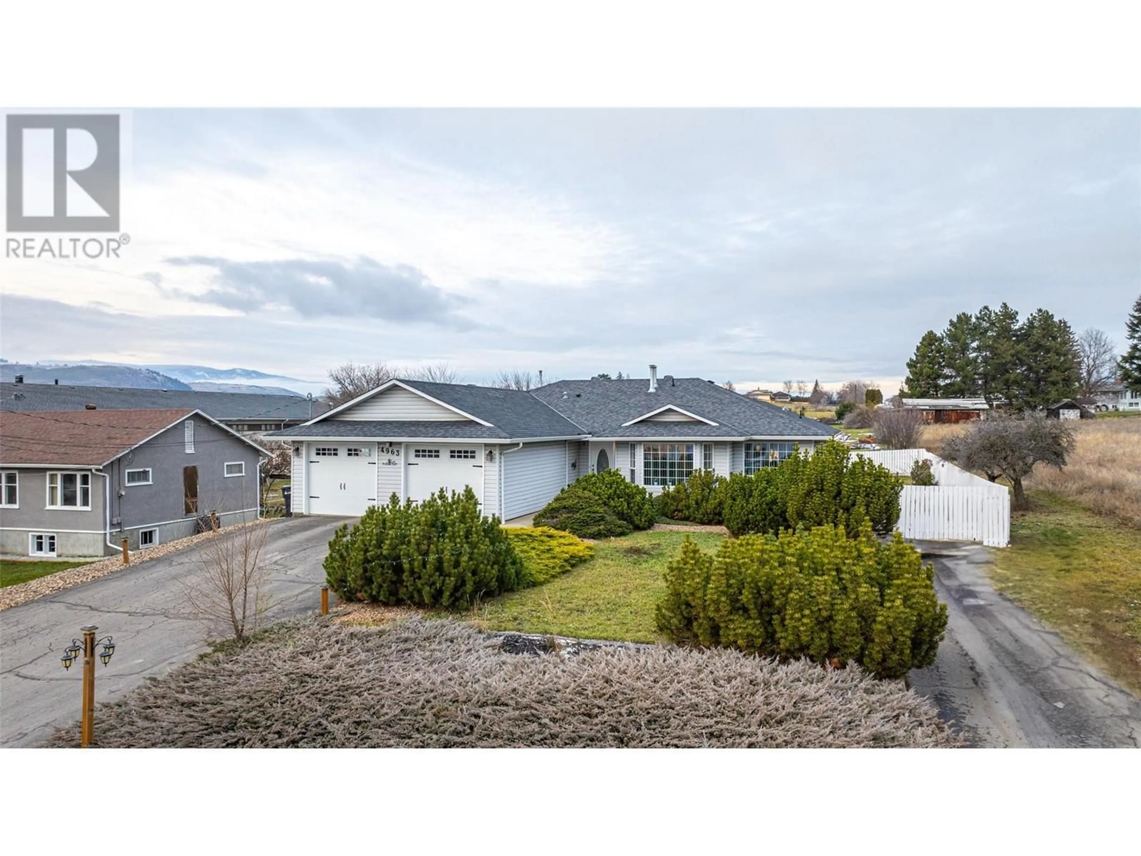 A pic from outside/outdoor area/front of a property/back of a property/a pic from drone, street for 4963 Silver Star Road, Vernon British Columbia V1B3K3