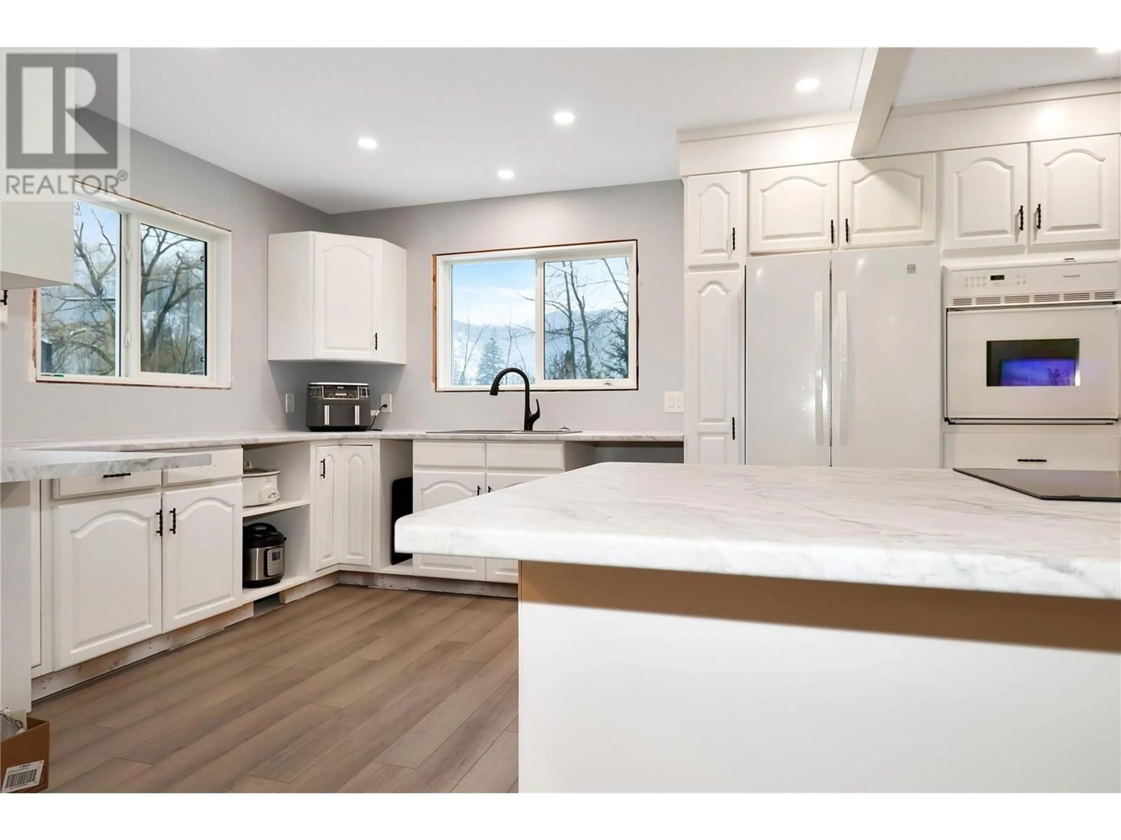 Open concept kitchen, wood/laminate floor for 1247 KIDD ROAD, Clearwater British Columbia V0E1N2